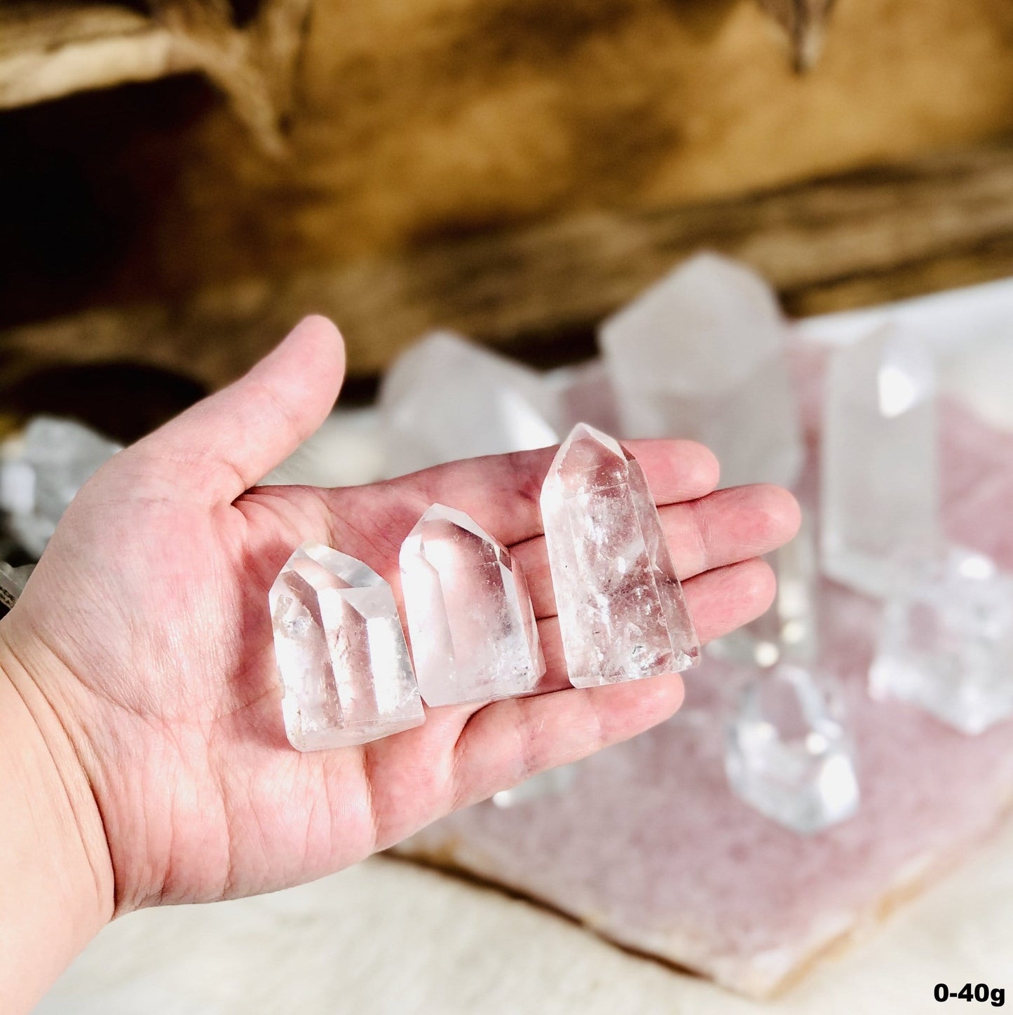 Crystal Quartz Polished Cut Base Points in a hand for size reference of under 40g