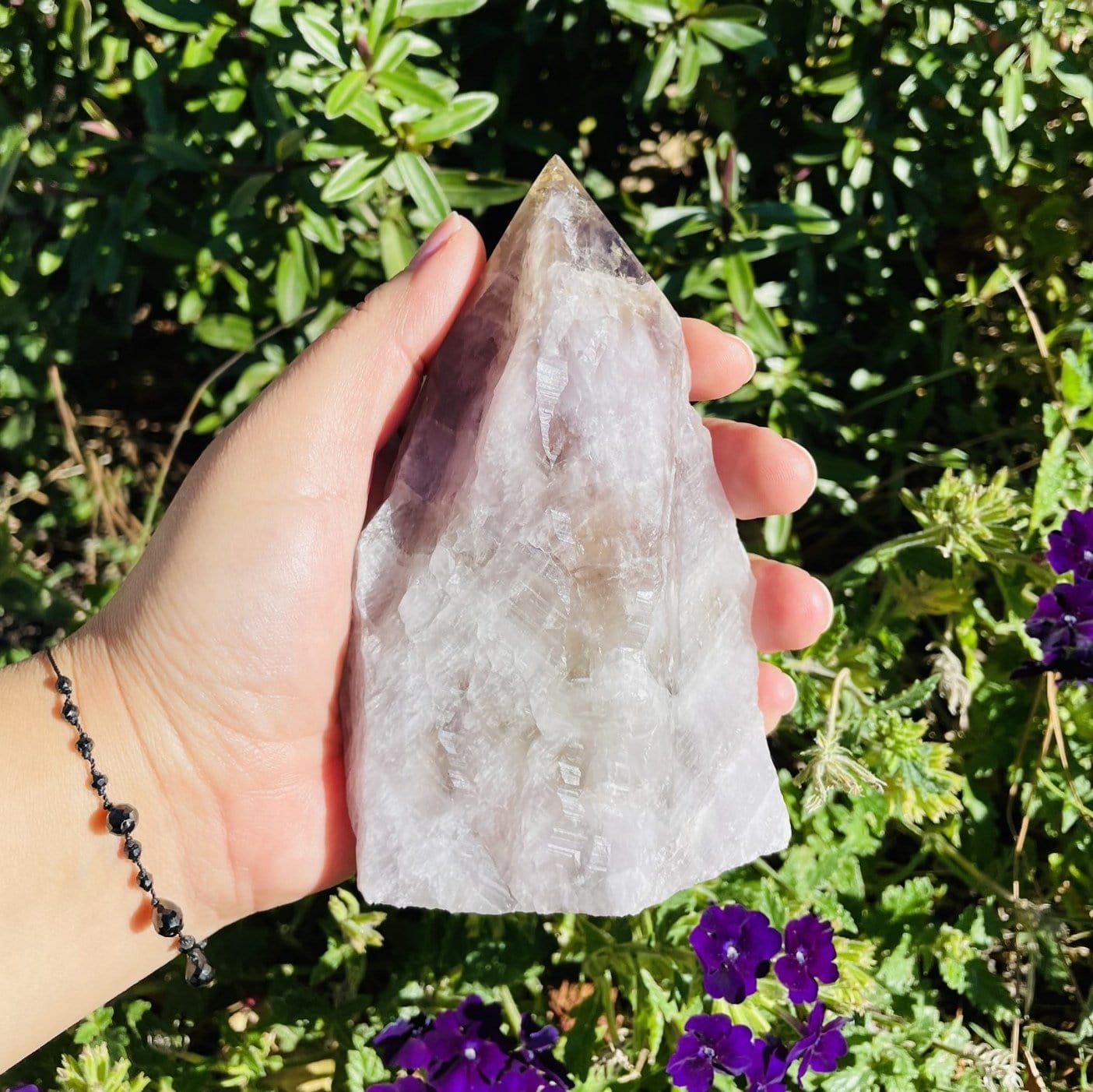 seven minerals in one polished point in hand for size reference 