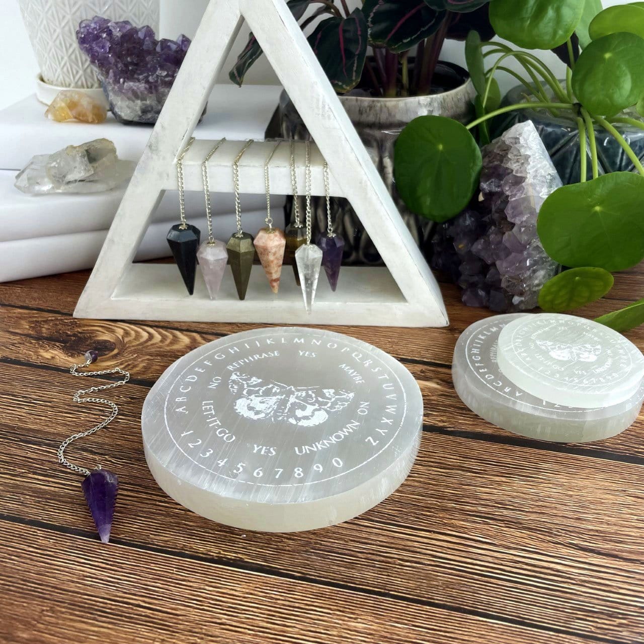 selenite moth pendulum board engraved charging plate on display