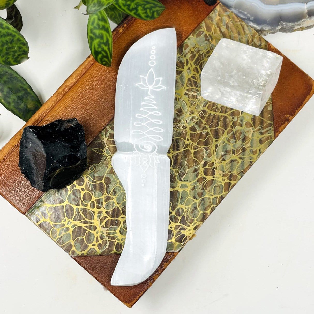 close up of one selenite knife with unalome engraving for details