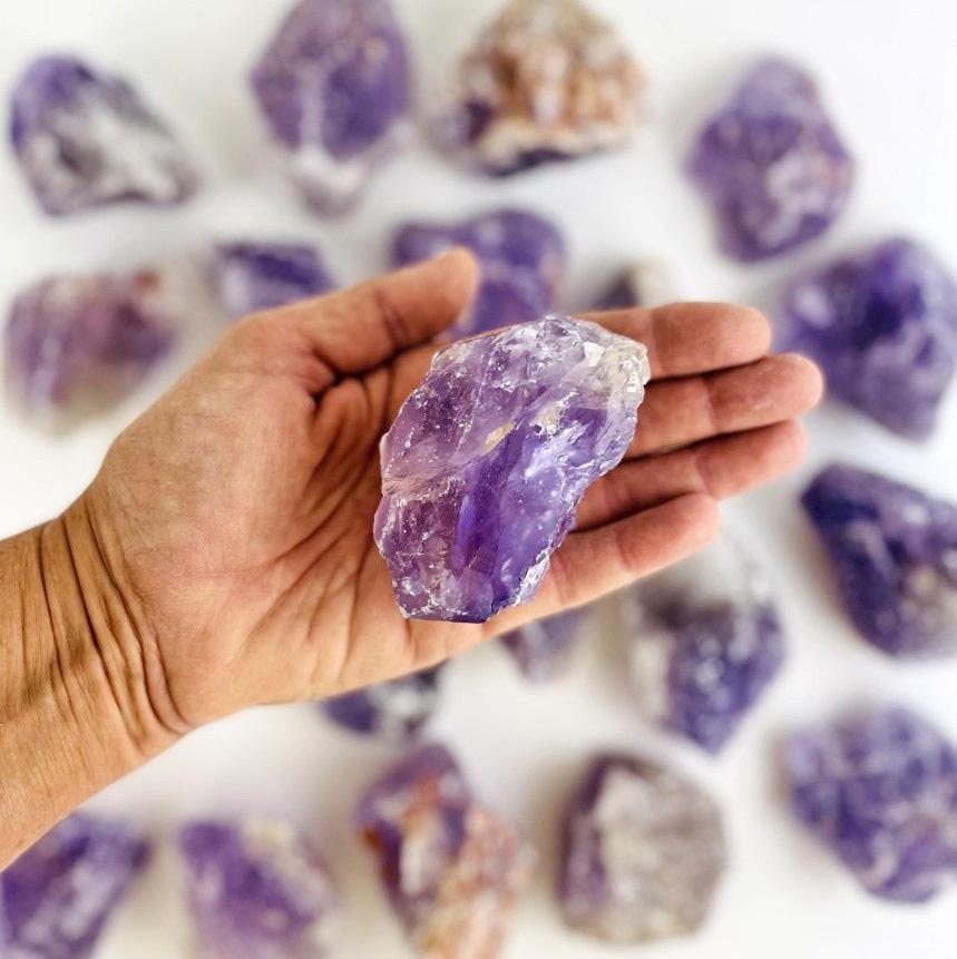 amethyst rough stone in hand 