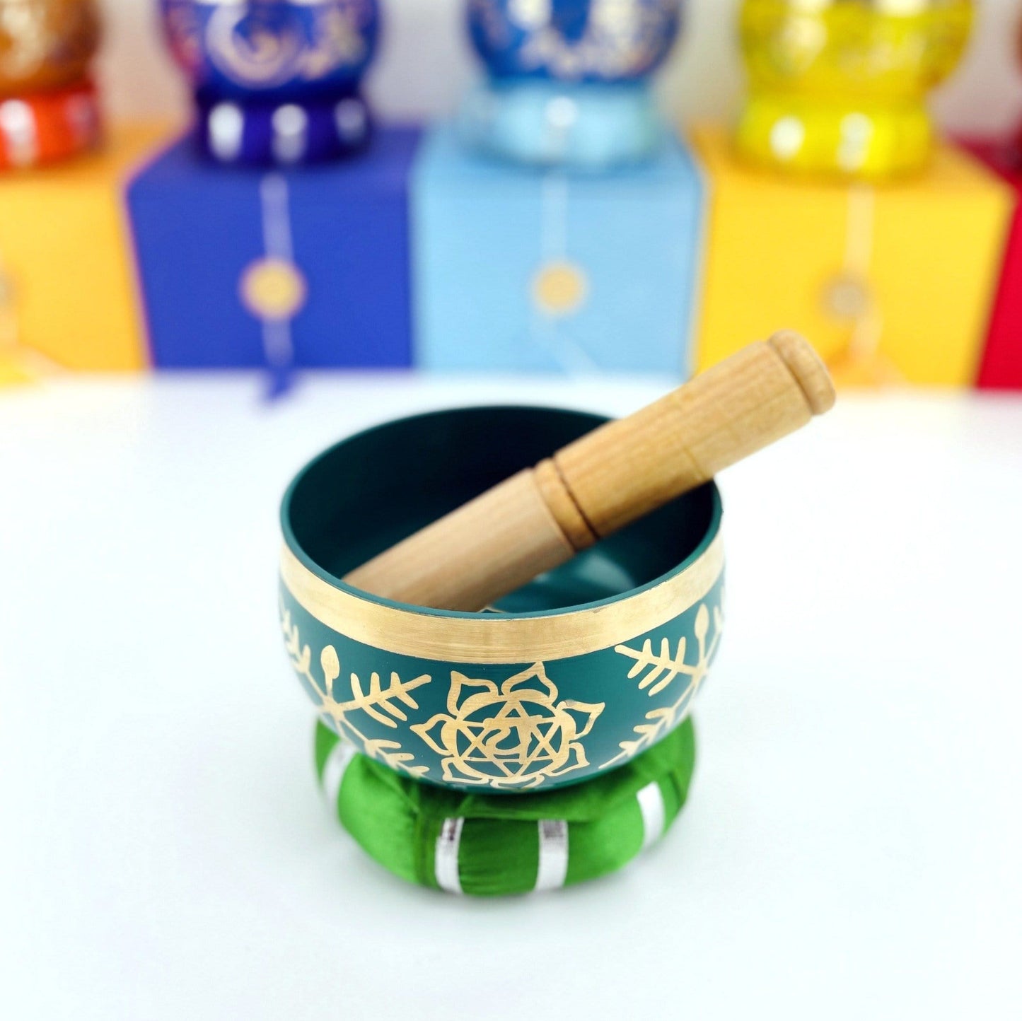 Brass Tibetan Singing Bowls - green bowl on a table