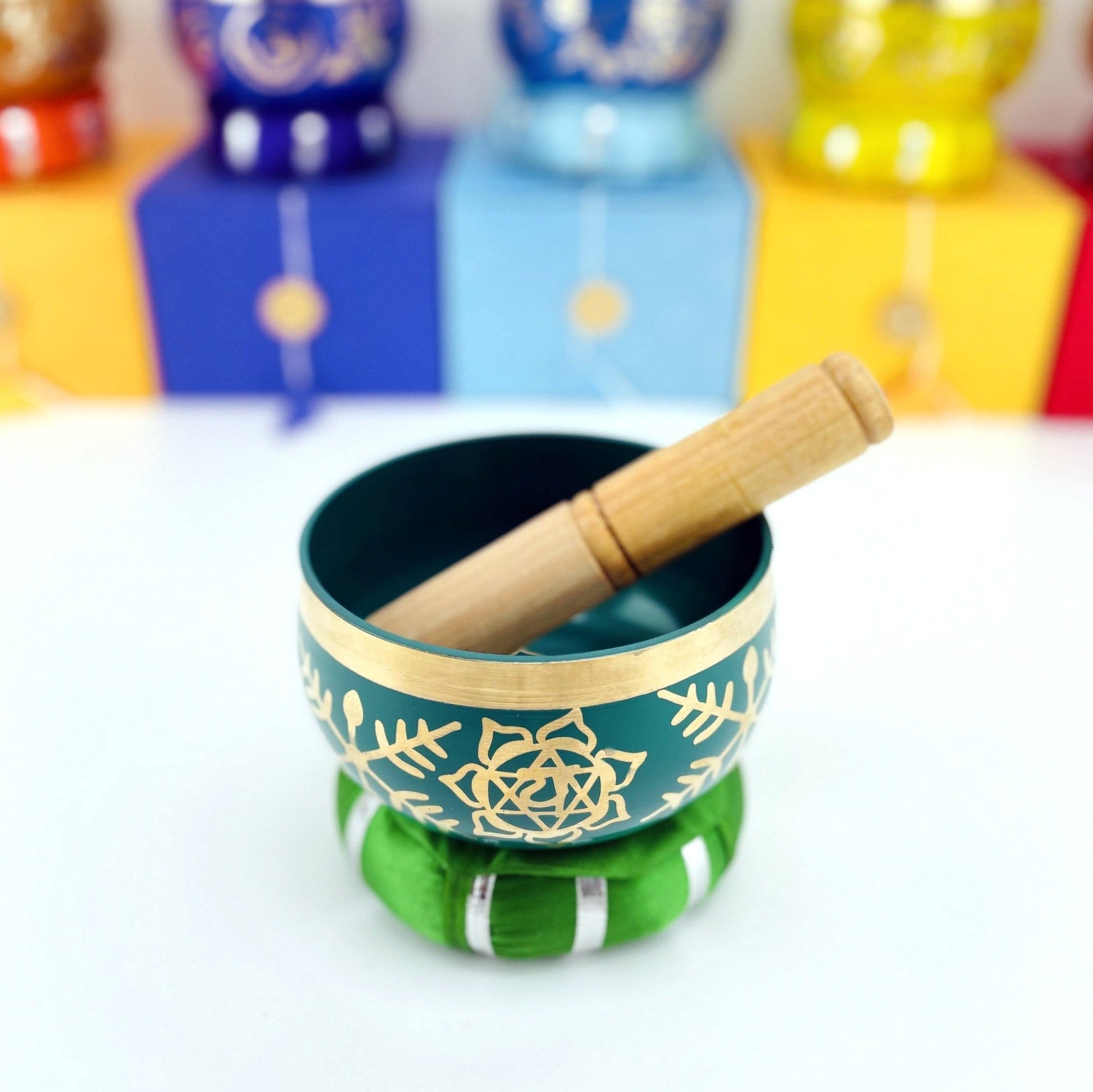 Brass Tibetan Singing Bowls - green bowl on a table