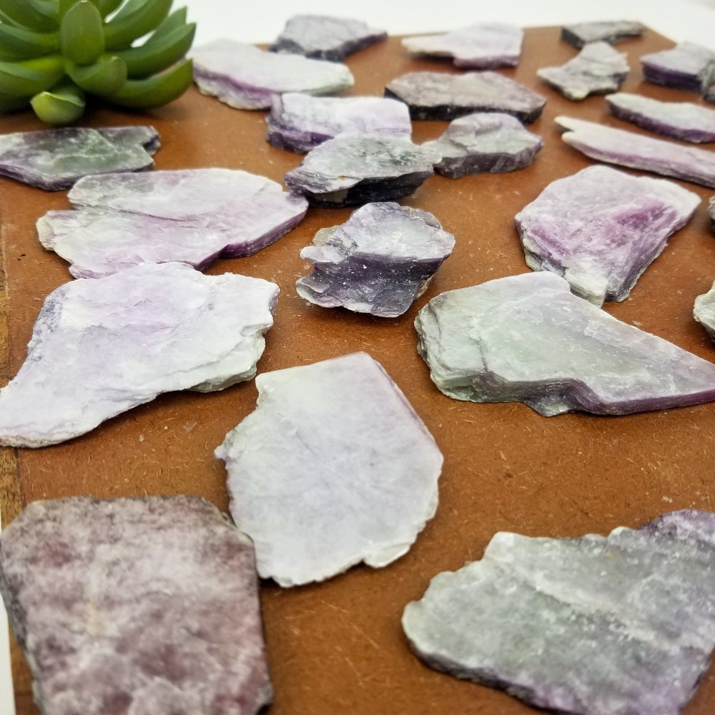 angled shot of lepidolite slices on brown background