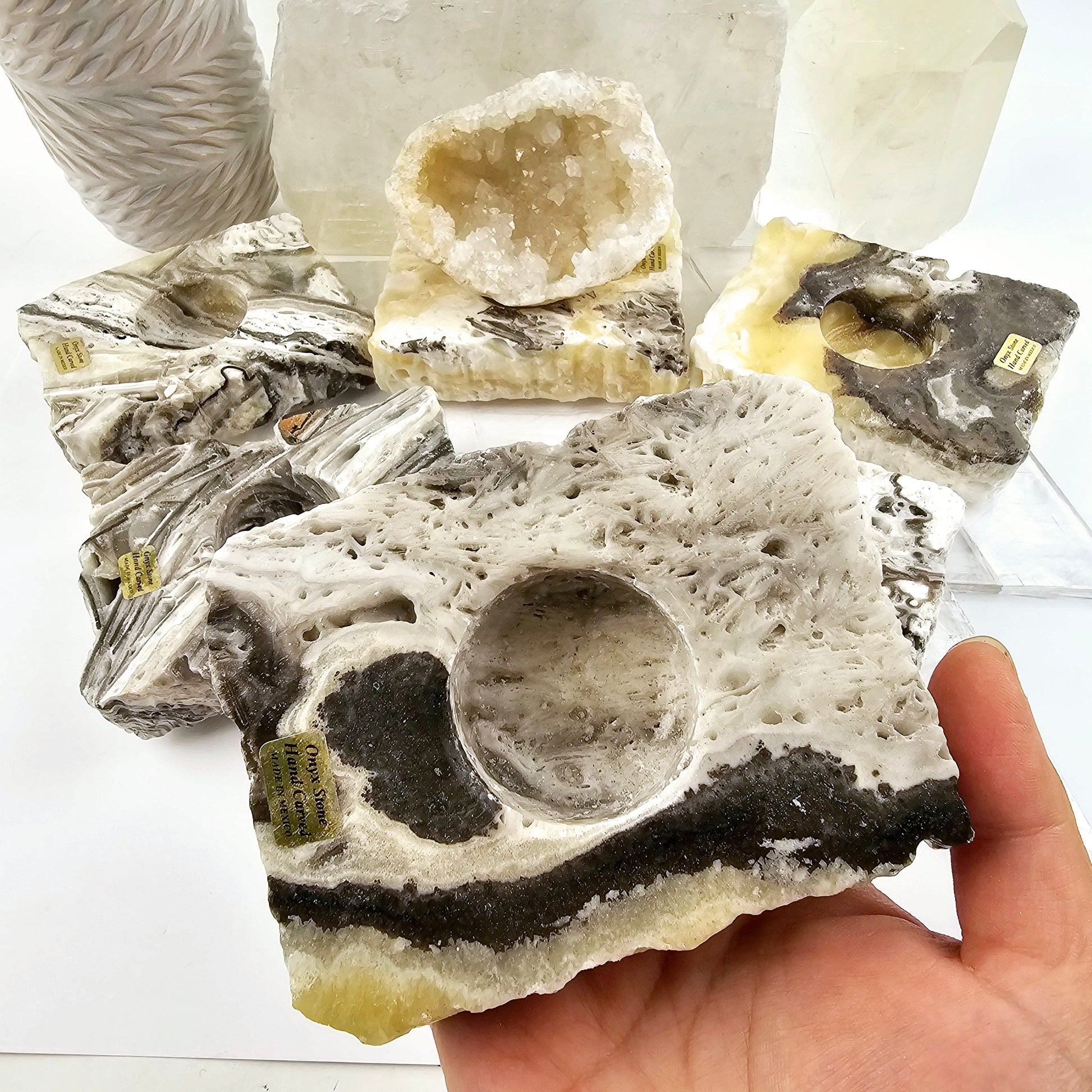 Mexican Onyx Crystal Sphere Holder - You Choose variant 6 in hand with other variants in the background for size reference