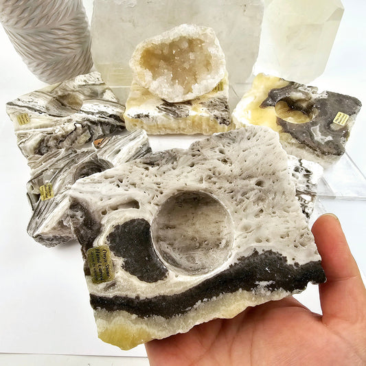 Mexican Onyx Crystal Sphere Holder - You Choose variant 6 in hand with other variants in the background for size reference