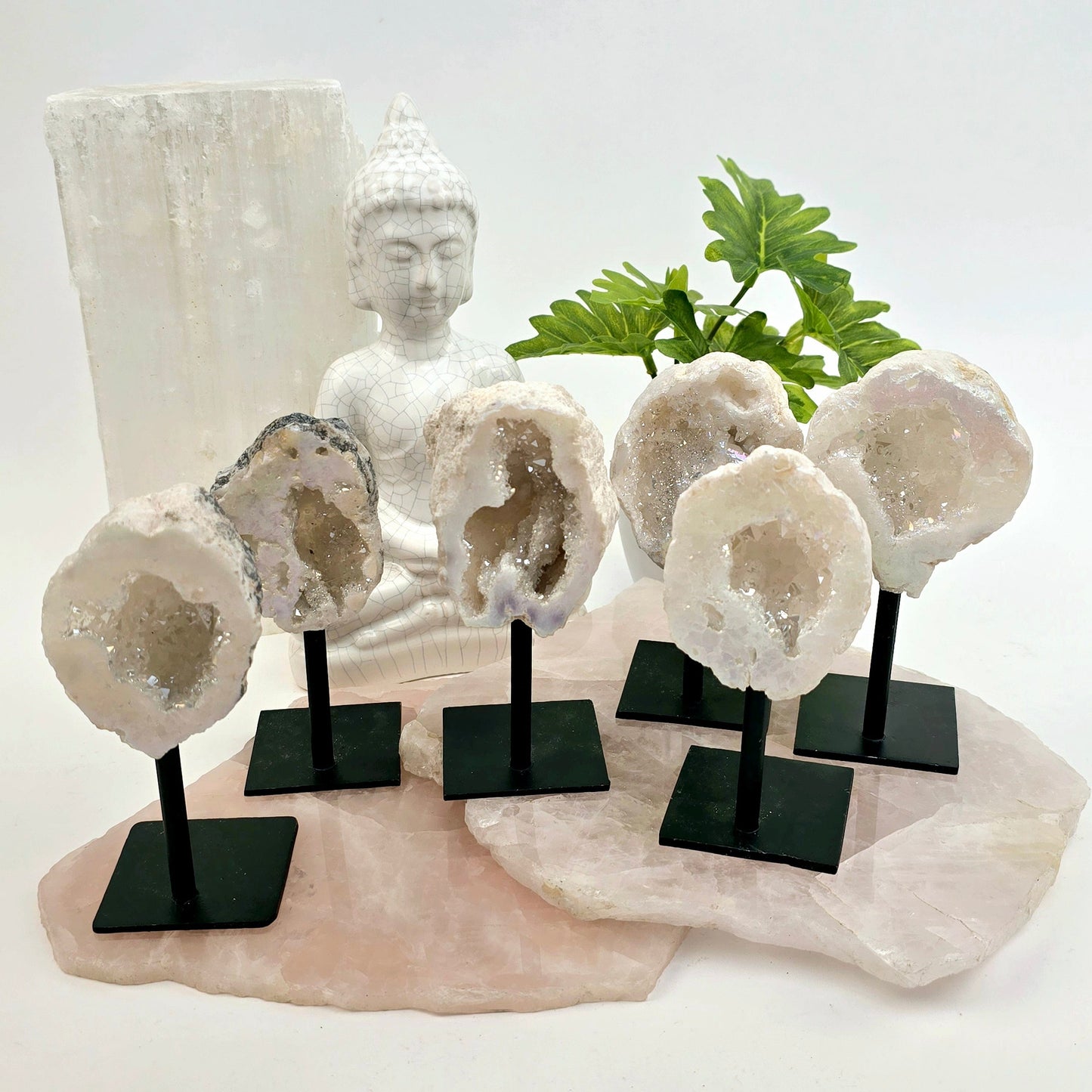Moroccan Aura Geode on Metal Stand six front view on stone platters with props and plants in the background