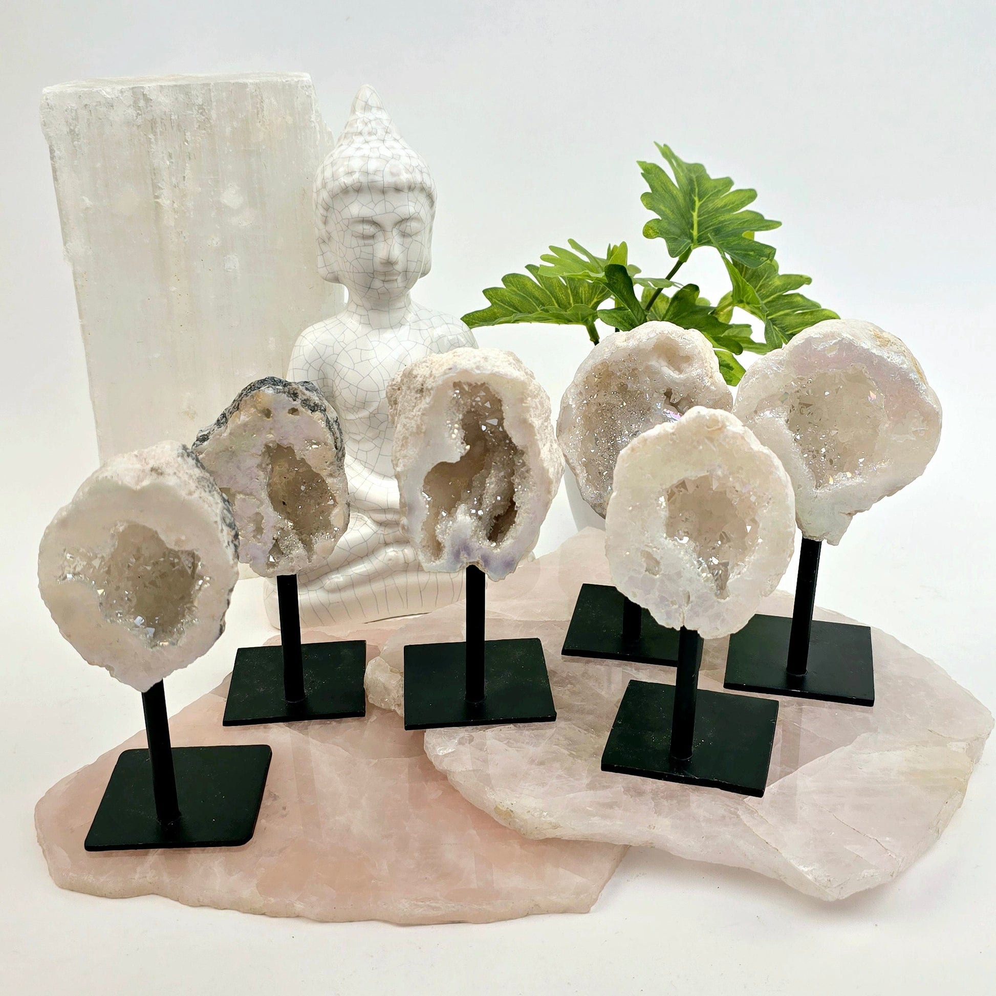 Moroccan Aura Geode on Metal Stand six front view on stone platters with props and plants in the background