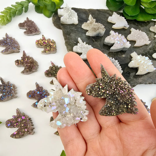 Druzy Unicorn Crystal Cabochon - Angel Aura or Rainbow Titanium Aura - You Choose Color - both colors in hand for size reference with others in the background with plants