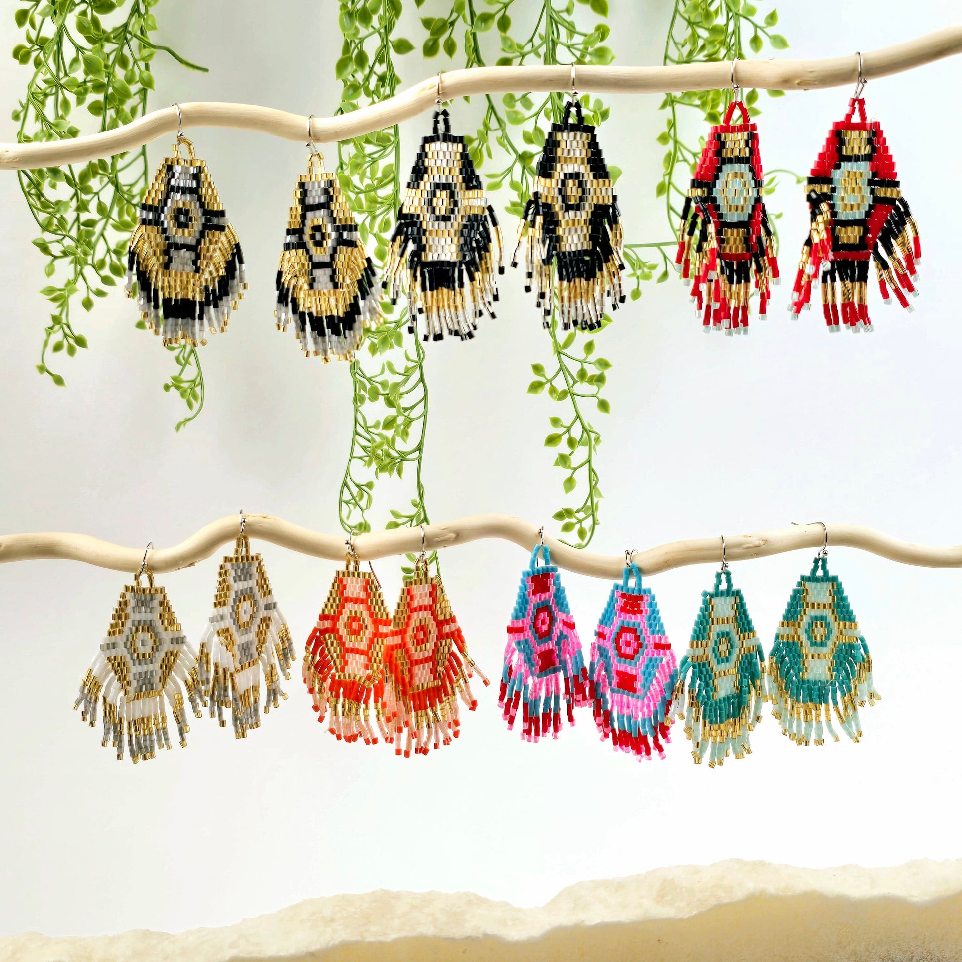 Seed Bead Earrings - Hexagon and Fringe Pattern - You Choose Style - all variants on white branches with plants and props in the background