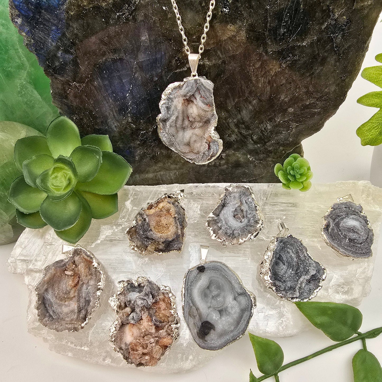 Chalcedony Galaxy Druzy Pendant with Silver Plated Edge and Bail - one on chain, seven on selenite platter to show variety, with plants and props in the background