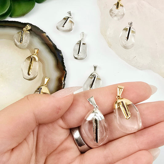 Crystal Quartz Tumbled Pendant with Black Tourmaline Accent and Silver or 24k Gold Electroplated Cap and Bail - You Choose Finish one of each variant in hand for size reference with others in the background with props and plants