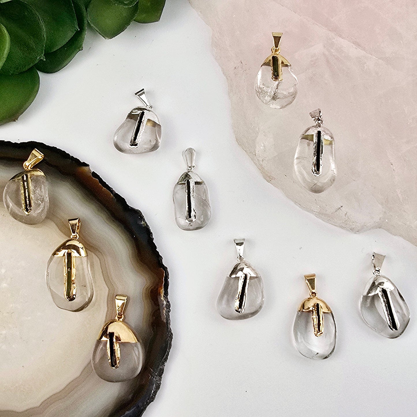Crystal Quartz Tumbled Pendant with Black Tourmaline Accent and Silver or 24k Gold Electroplated Cap and Bail - You Choose Finish both variants on stone platters with plants in the background