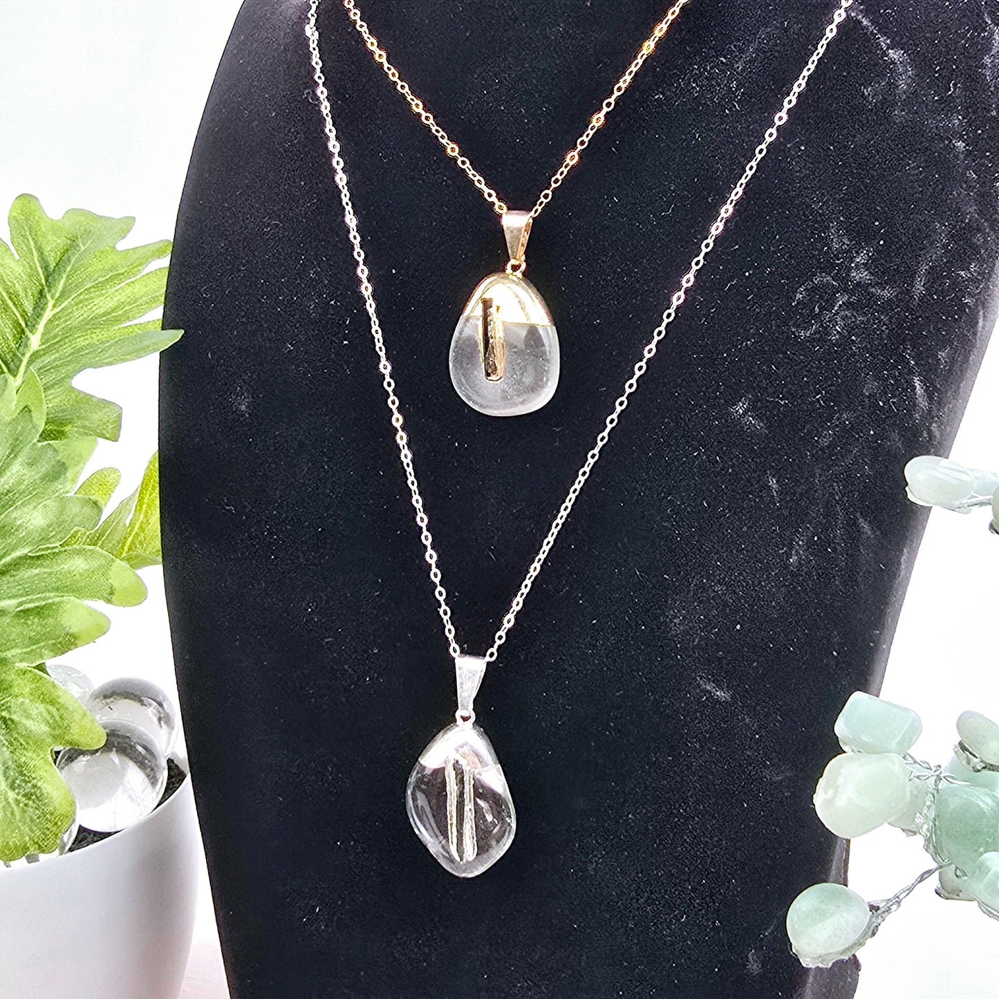 Crystal Quartz Tumbled Pendant with Black Tourmaline Accent and Silver or 24k Gold Electroplated Cap and Bail - You Choose Finish on chains with plants and props in the background