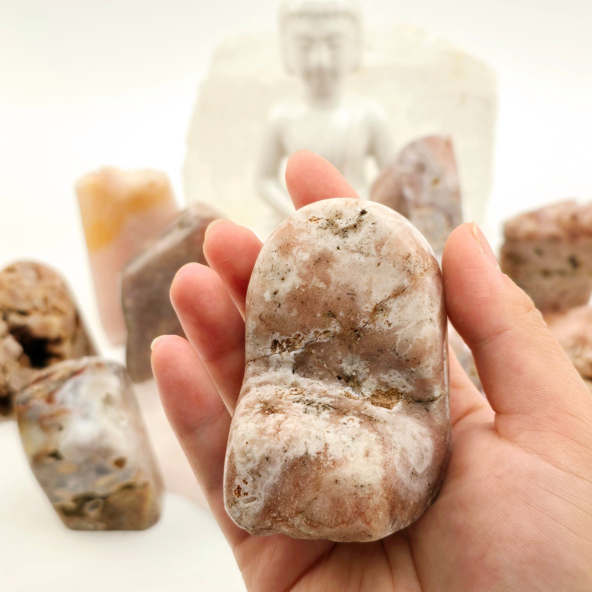 Pink Amethyst Polished Crystal Freeform - You Choose #1 variant 2 in hand for size reference with other variants in the background with props