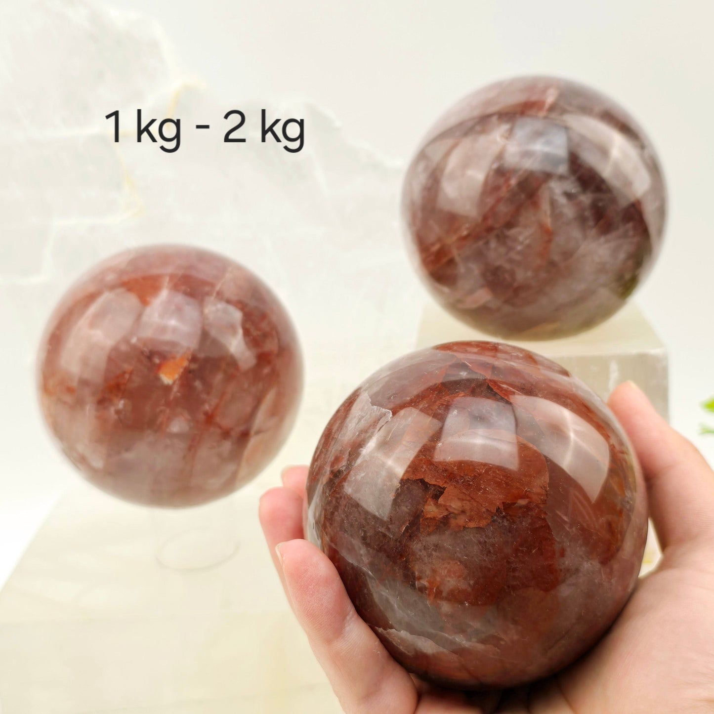 Guava Quartz Polished Crystal Sphere - By Weight variant 1 kg - 2 kg labeled one in hand for size reference
