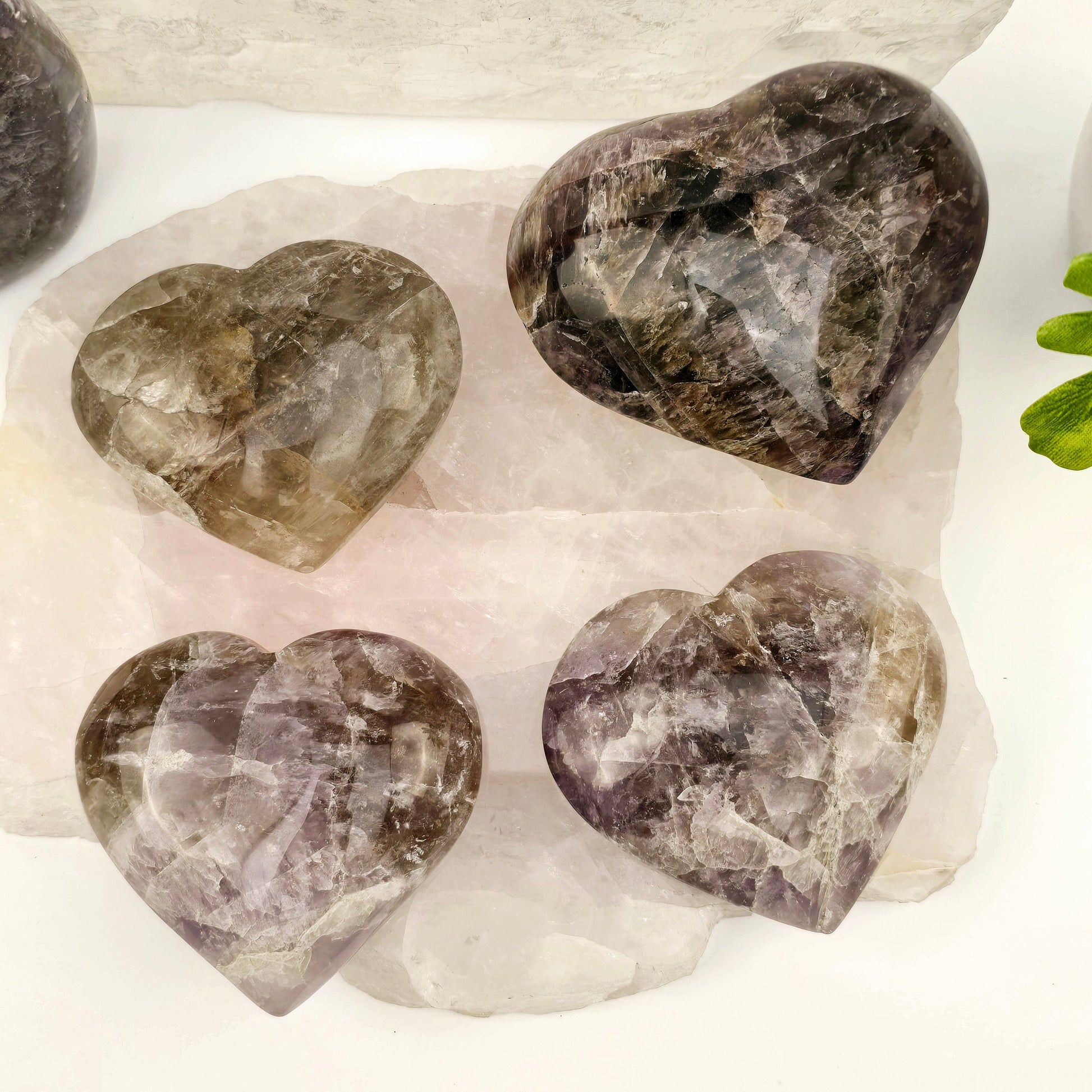 Amethyst Super Seven Polished Crystal Heart YOU CHOOSE all variants on rose quartz platter with props and plants in the background
