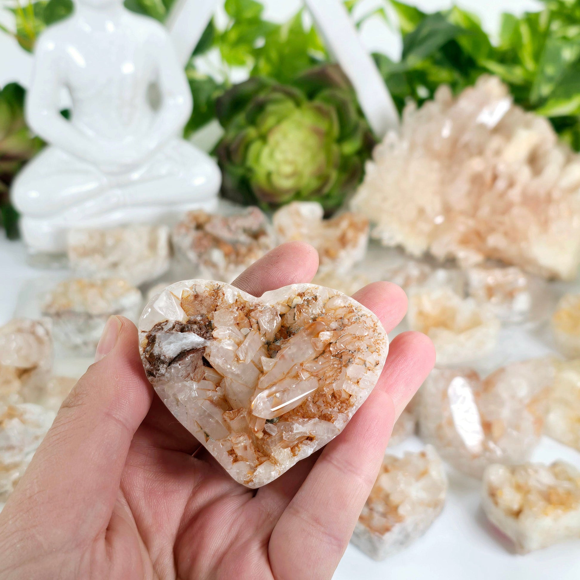 Tangerine Quartz Polished Crystal Cluster Heart - You Choose #2 one in hand for size reference with other variants in the background with props and plants