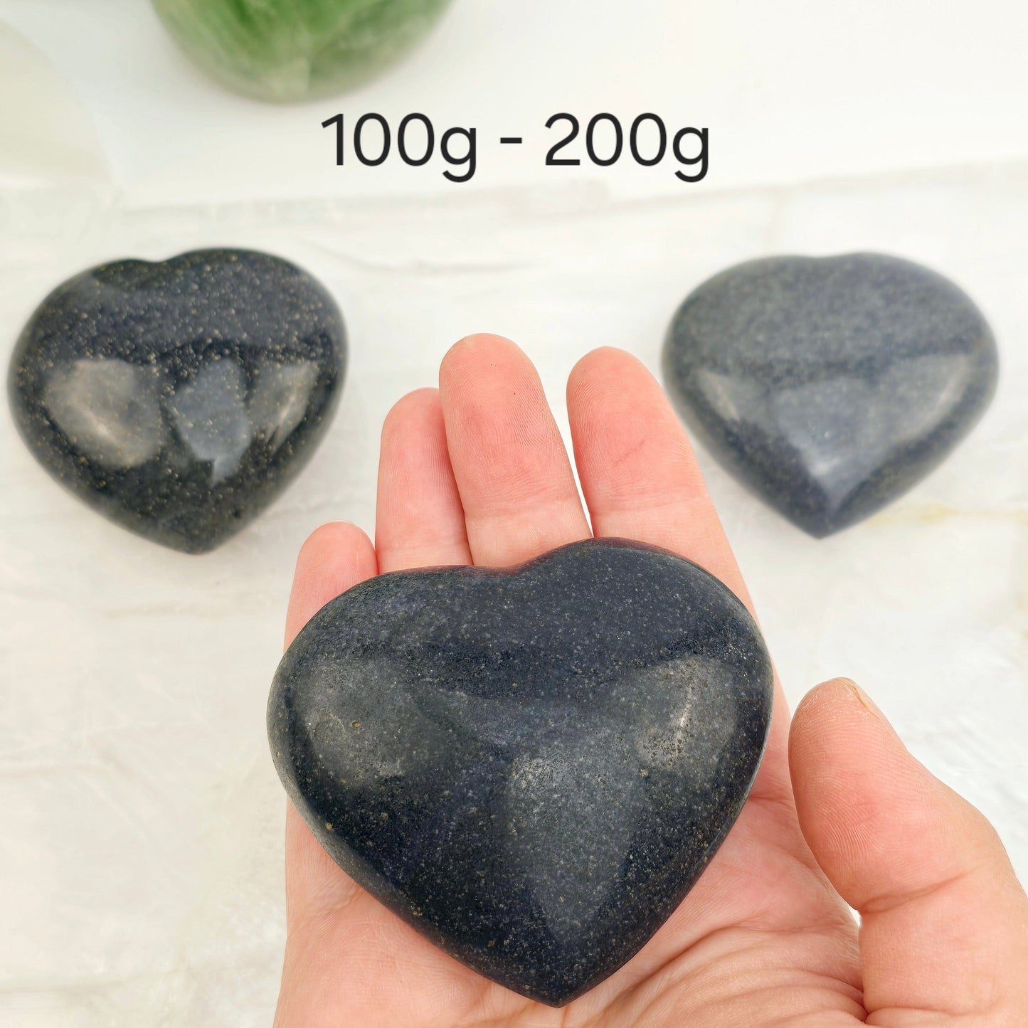 Lazulite Crystal Heart - By Weight 100g-200g weight variant labeled with one in hand for size reference