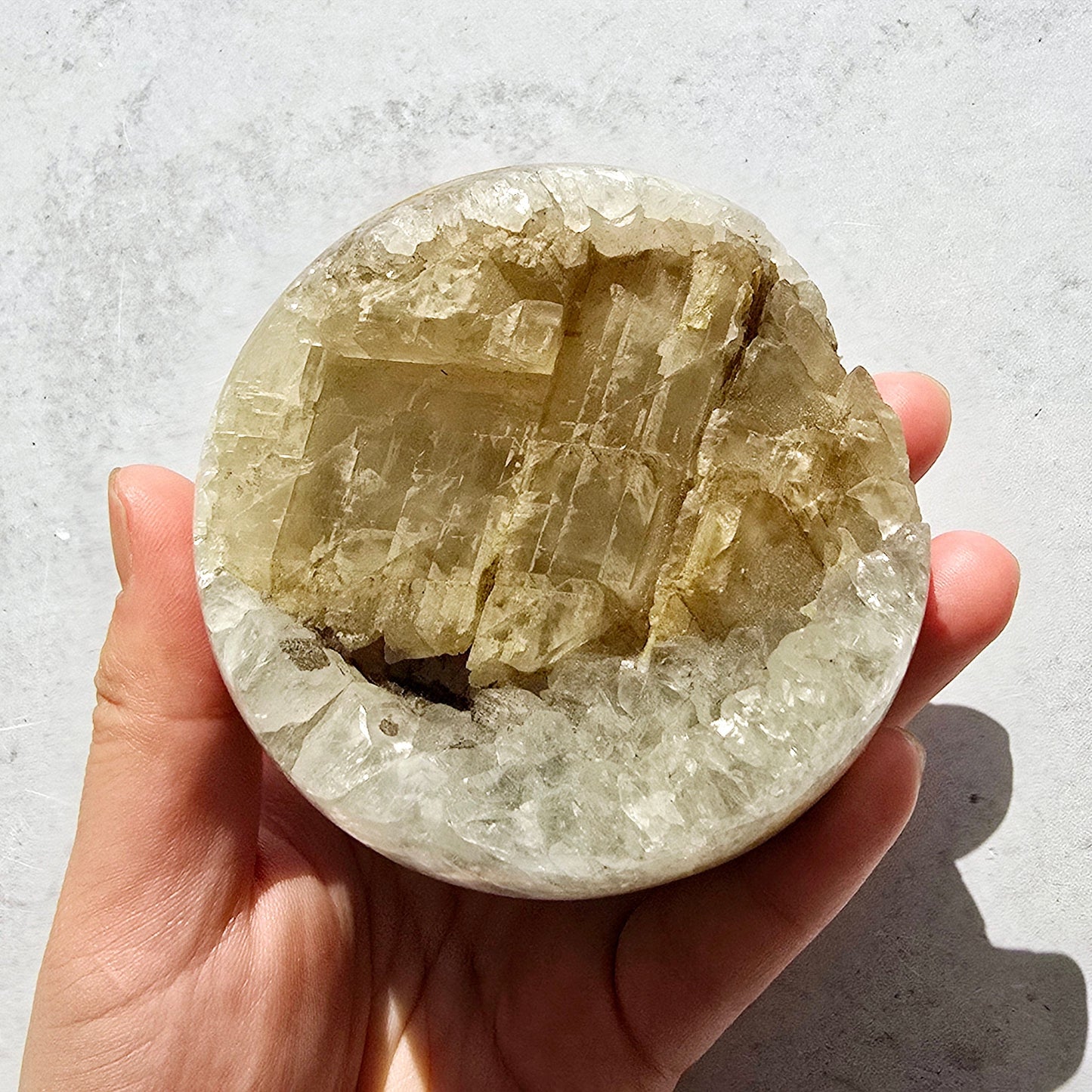 Crystal Quartz Cluster with Calcite Sphere - One-of-a-Kind in sunlight in hand for size reference