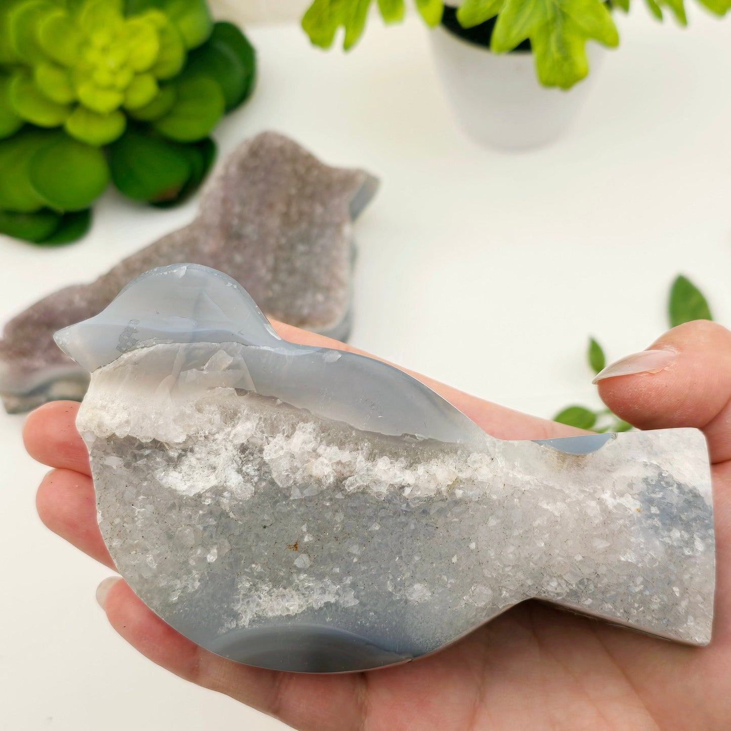 Agate Amethyst Cluster Polished Crystal Bird - You Choose variant 2 in hand for size reference with other variant in the background with plants