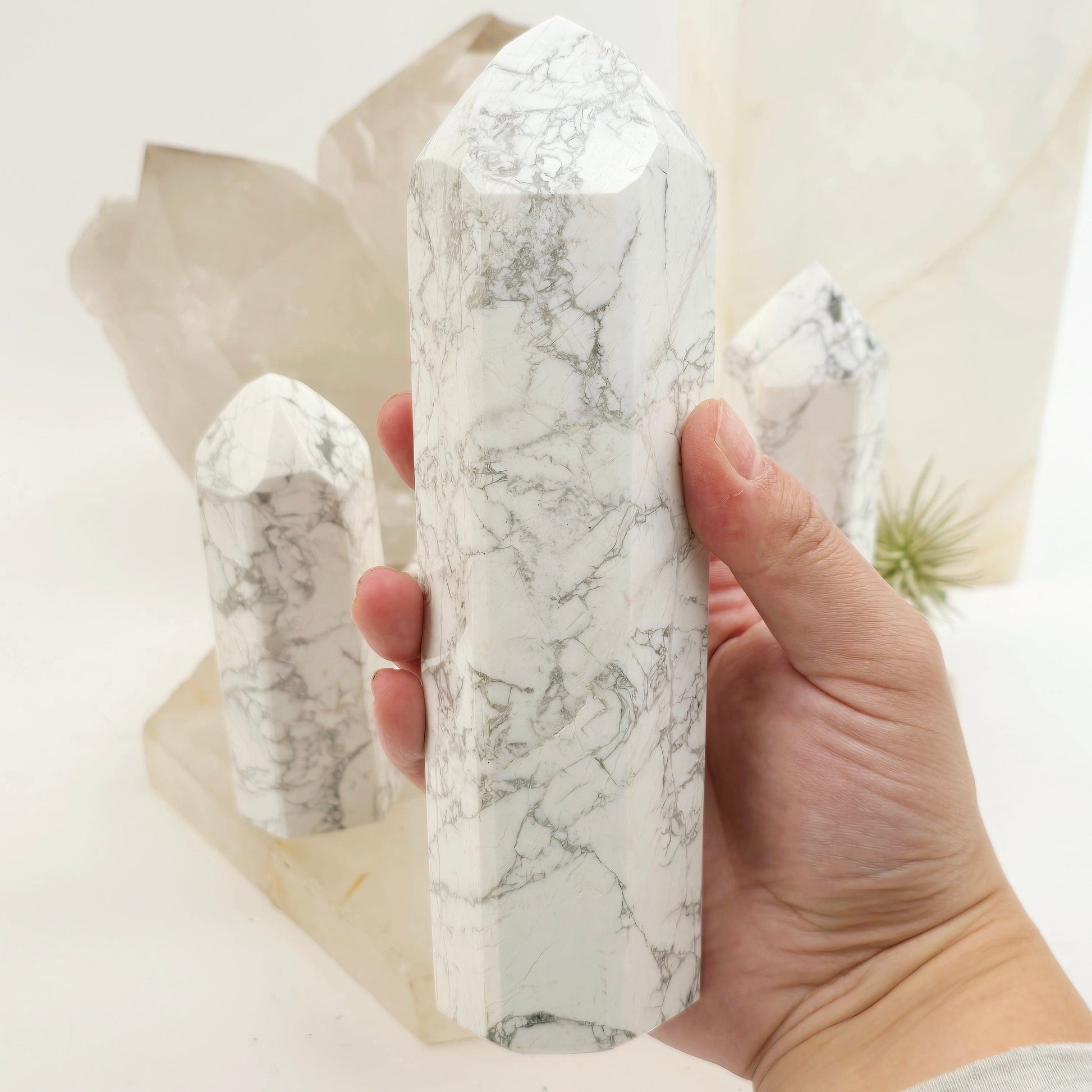 White Howlite Crystal Obelisk - You Choose #1 variant 3 in hand for size reference with other variants in the background