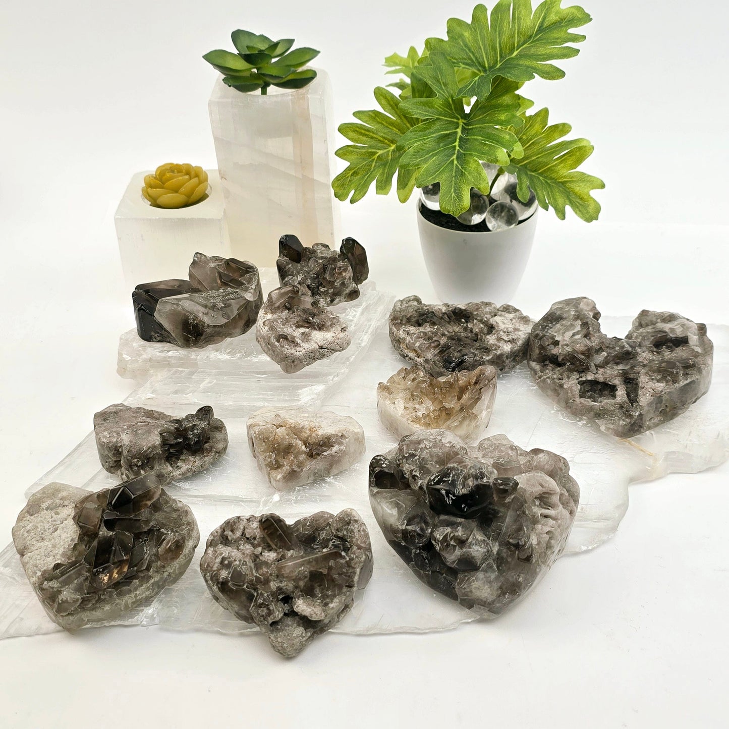 Smokey Quartz Polished Crystal Cluster Heart - You Choose all variants side view with props and plants in the background
