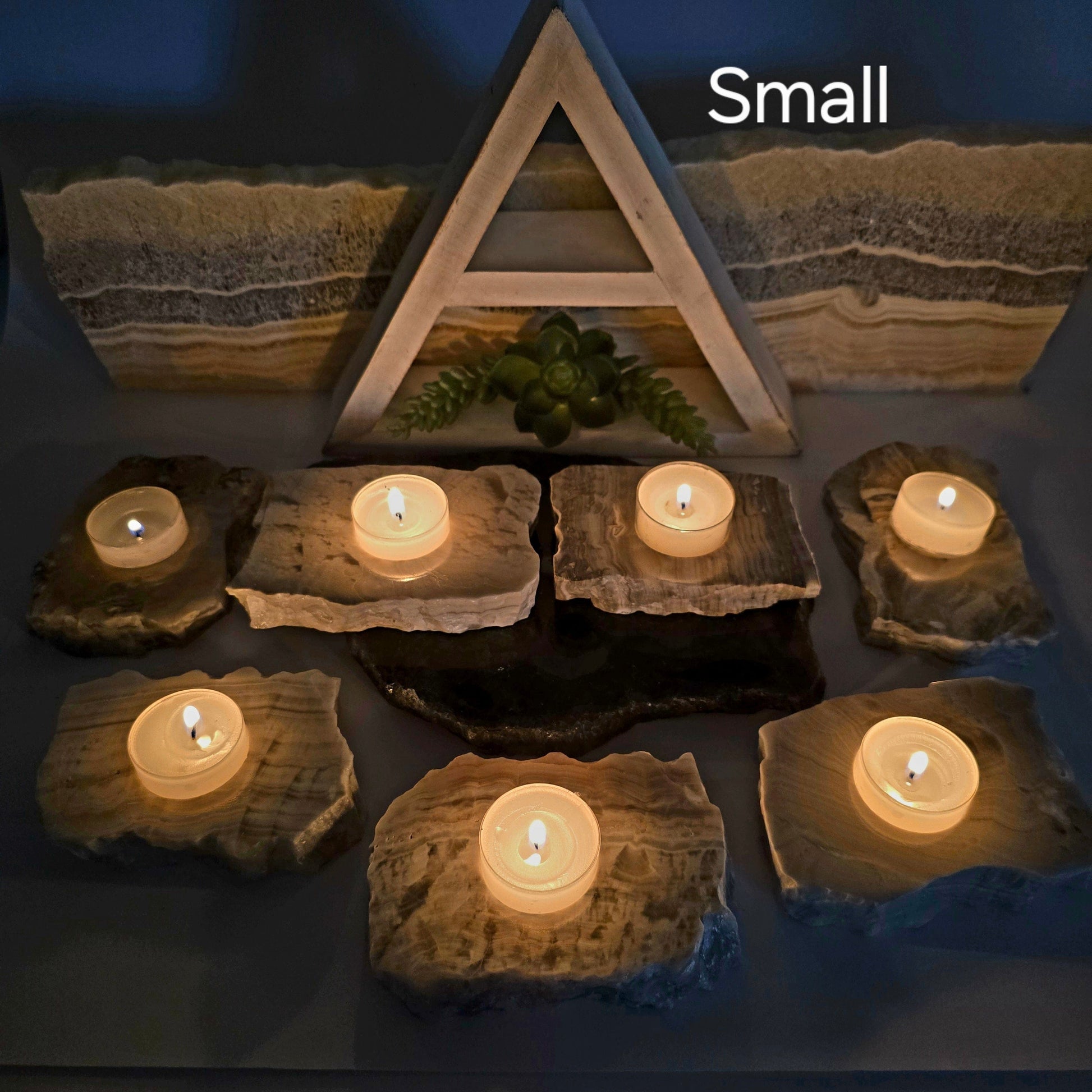 Grey Travertine Calcite - Grey Onyx - Crystal Candle Holder - By Size small variant labeled with candles lit in dark background