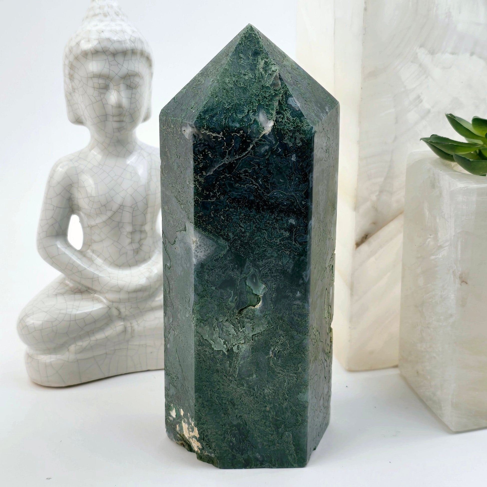 Moss Agate Crystal Obelisk - One-of-a-Kind front view with props and plants in the background