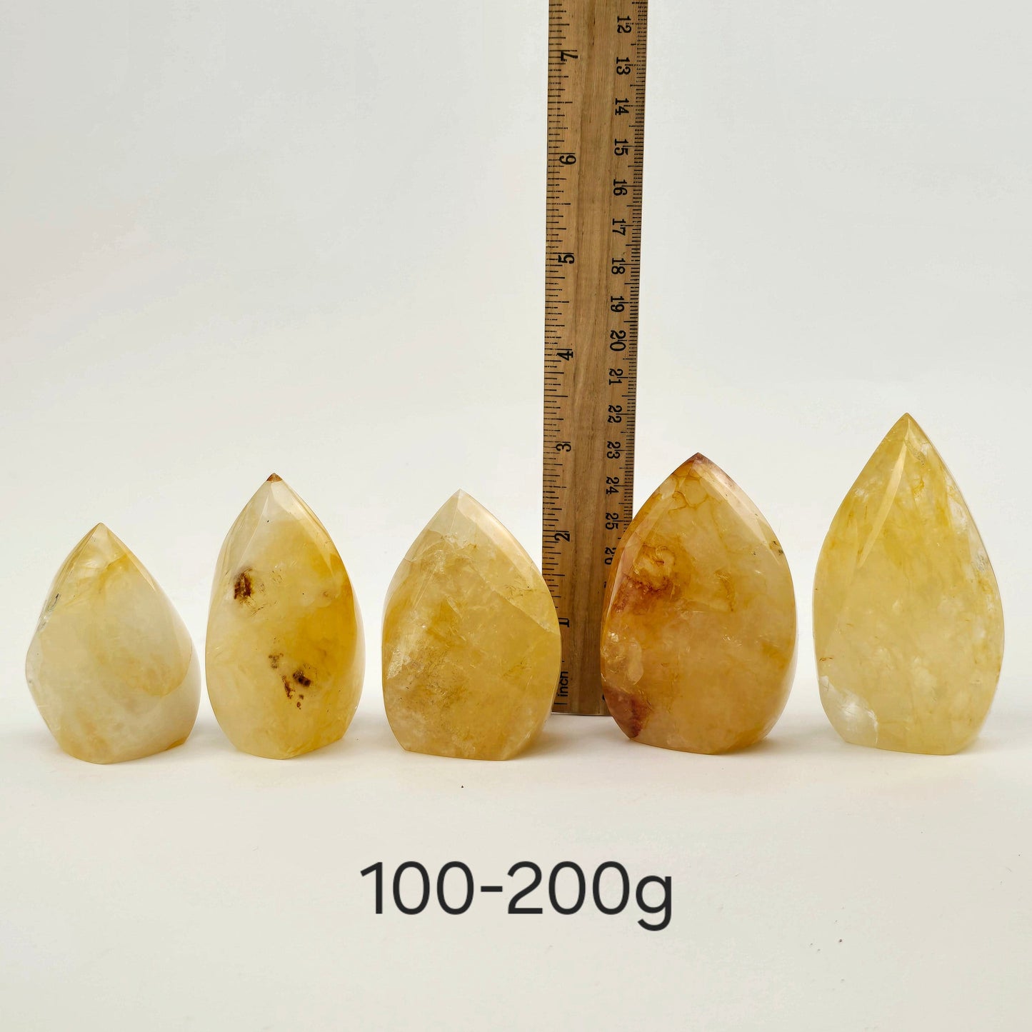 Golden Healer Crystal Flame Point Cut Base - By Weight 100-200g variant labeled with ruler for size reference