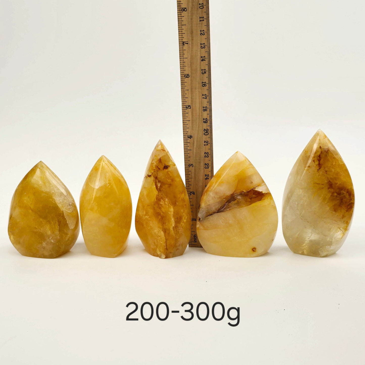 Golden Healer Crystal Flame Point Cut Base - By Weight 200-300g variant labeled with ruler for size reference