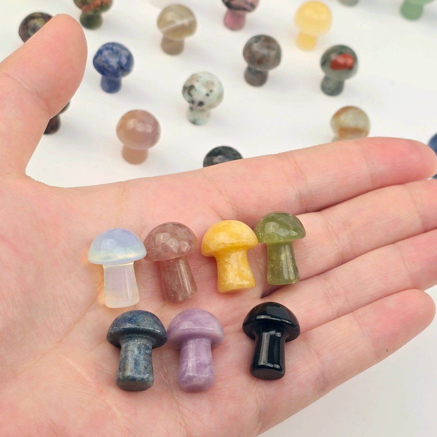 Gemstone Mushroom - Small Crystal Carving - Available in Set of 10 - You Choose Stone seven variants in hand for size reference with other variants in the background