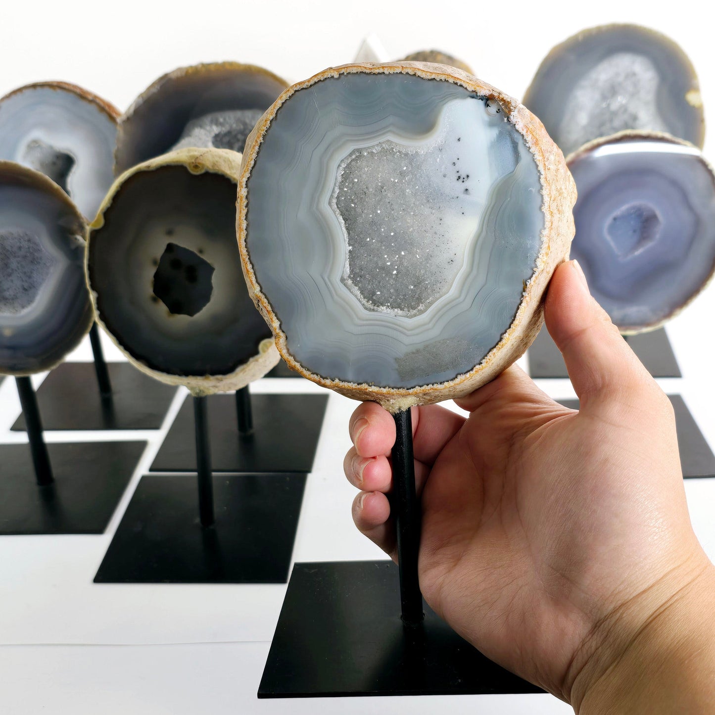 Agate Natural Crystal Geode Half on Stand - You Choose #3 one variant in hand for size reference with other variants in the background