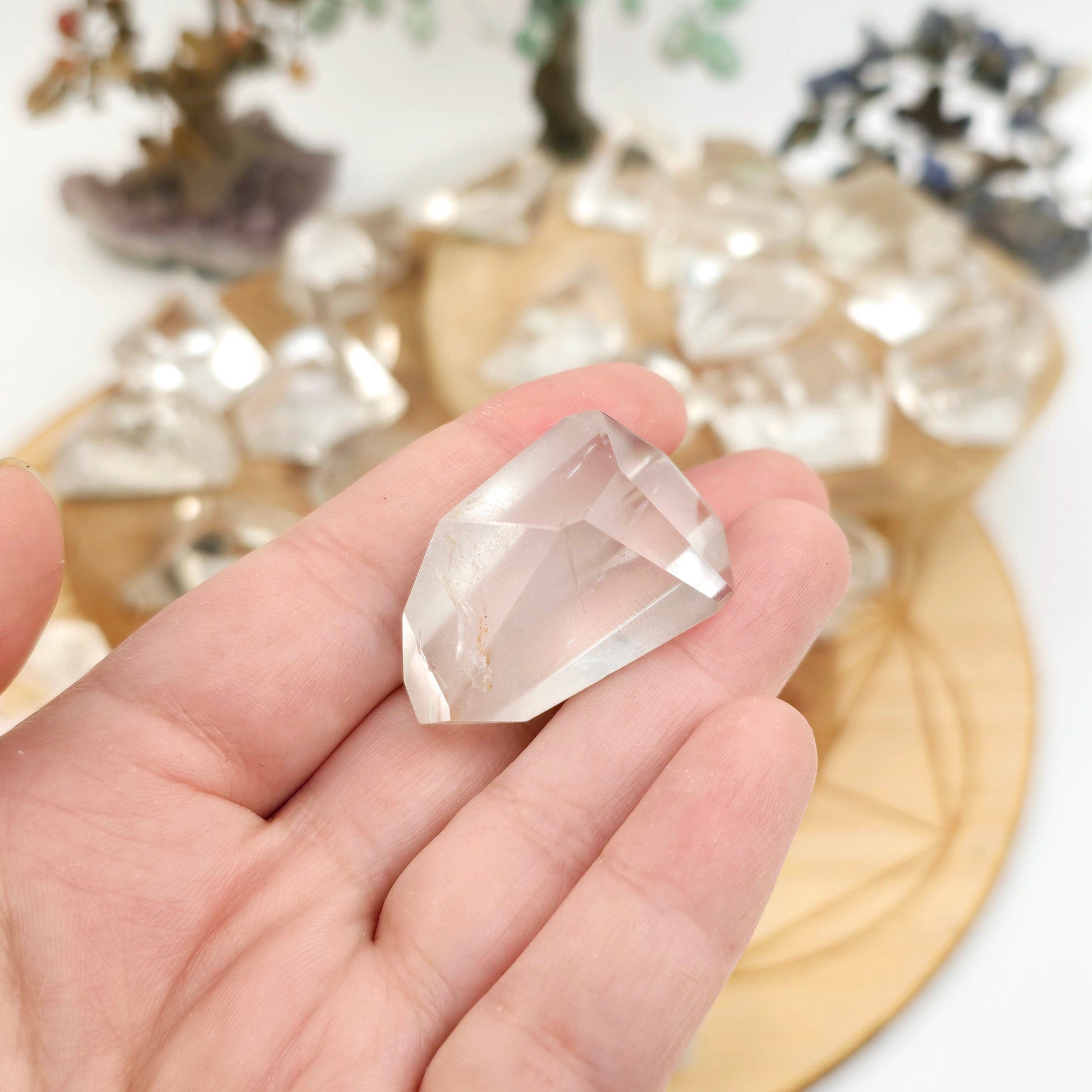 Crystal Quartz Freeform High Quality Polished Crystals from Brazil - You Choose #1 variant 4 in hand for size reference with other variants in the background with props