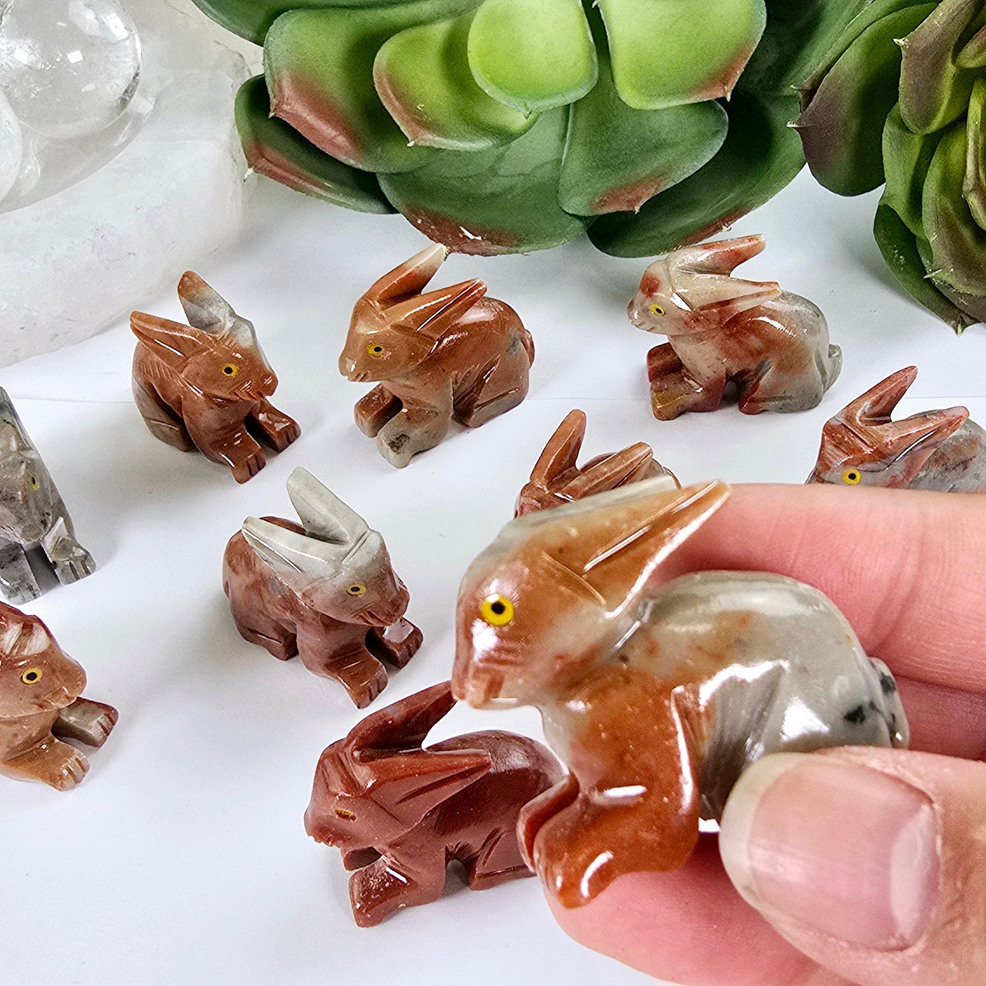 Soapstone Crystal Rabbit Carving from Peru - You Choose one in hand for size reference with others in the background with props and plants