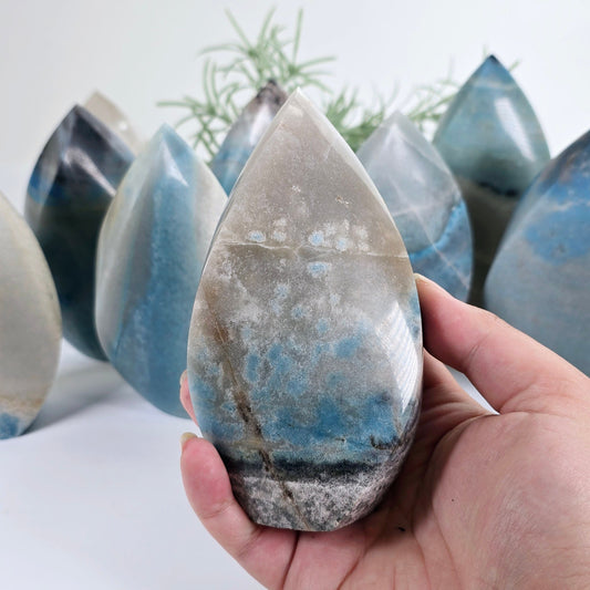 Trolleite Crystal Flame Point - You Choose #1 one variant in hand for size reference with other variants in the background