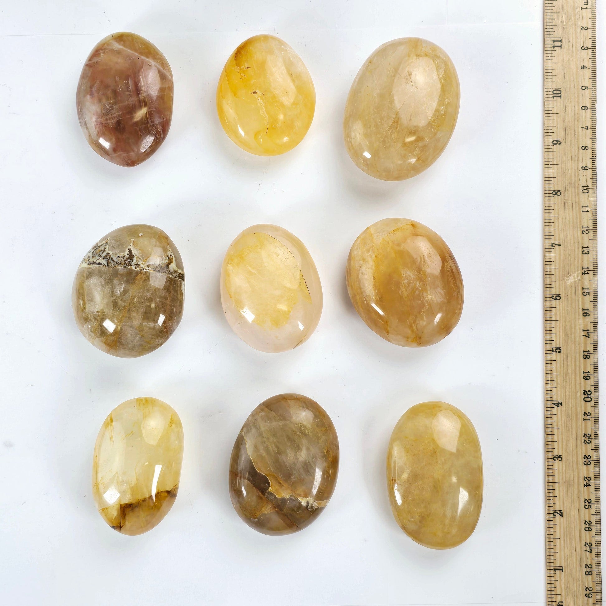 Golden Healer Crystal Palm Stone nine stones top view with ruler for size reference