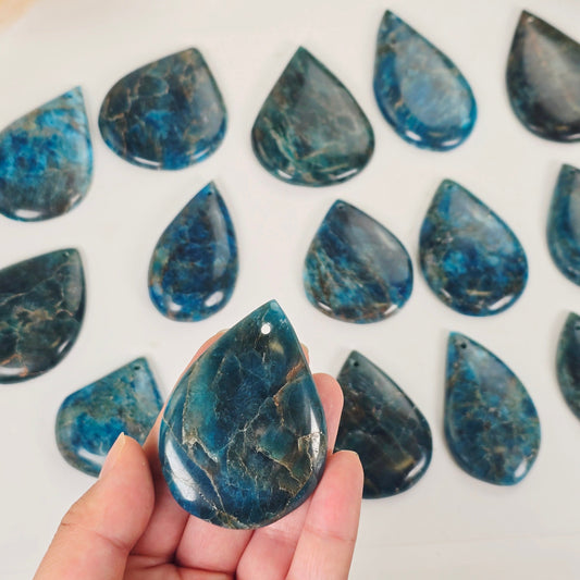 Apatite Polished Crystal Teardrop Pendant - You Choose one variant in hand for size reference with others in the background