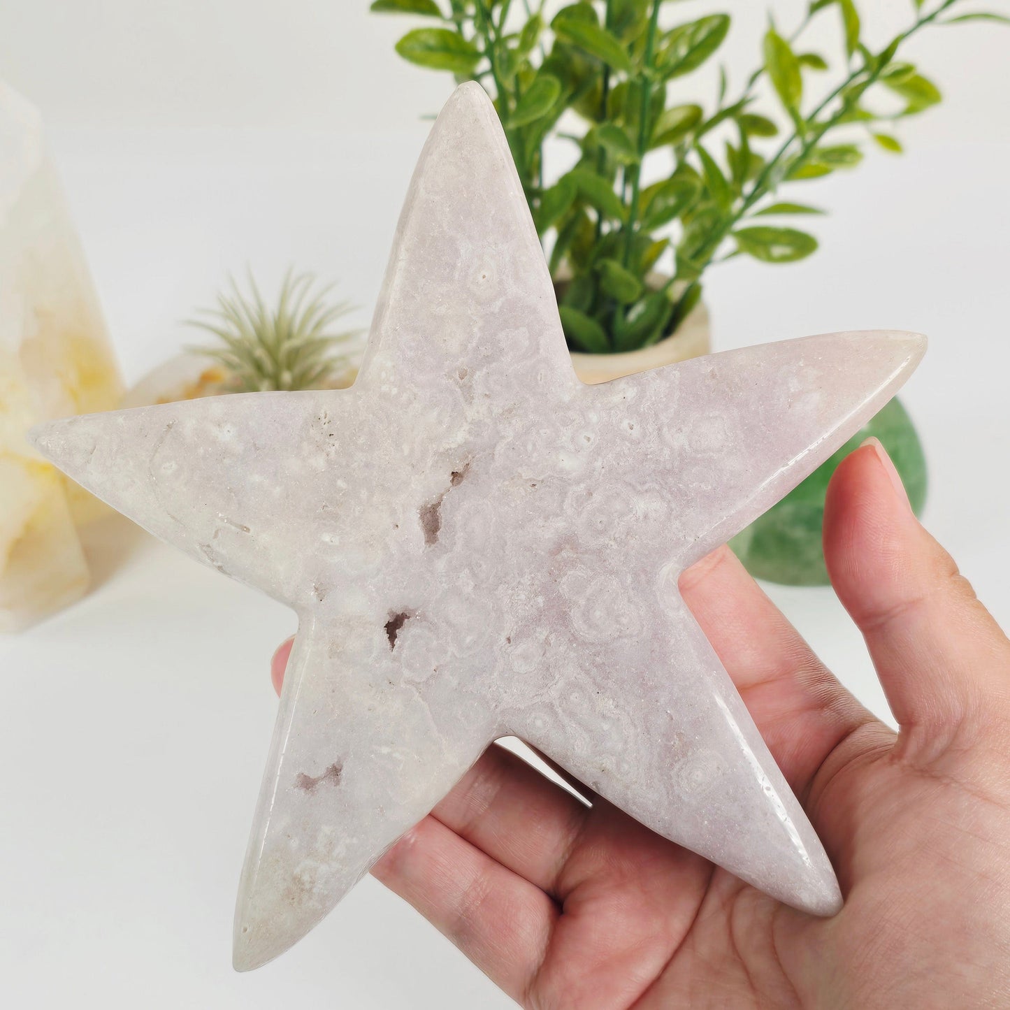Pink Amethyst Crystal Star - One-of-a-Kind #1 in hand for size reference with props and plants in the background