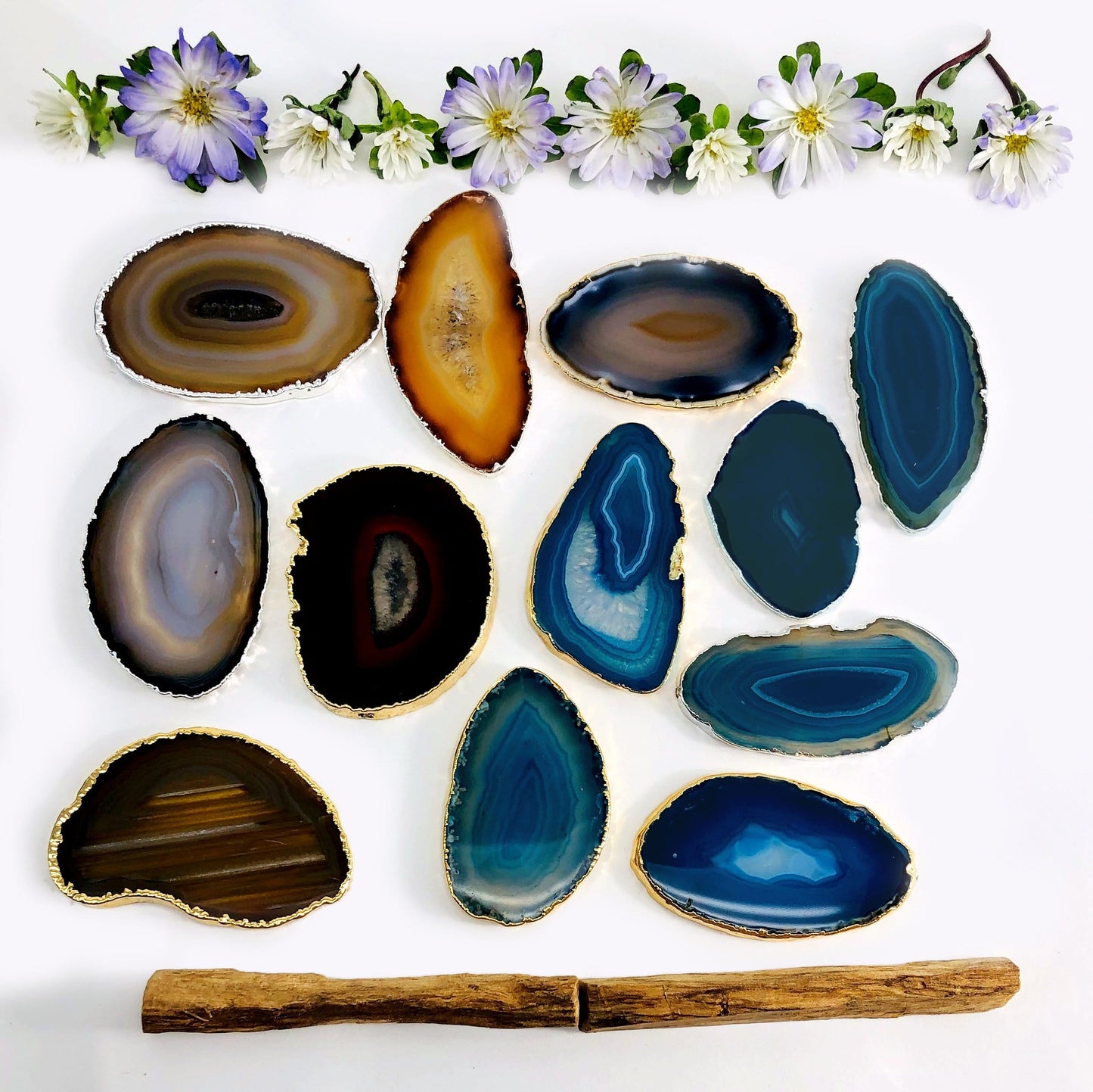 Picture of our black and blue agate slices plated edge being displayed on a white background. 