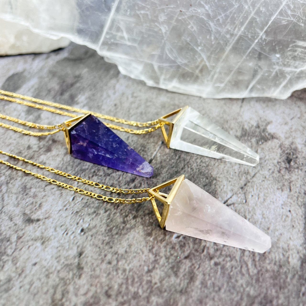 Rose Quartz Amethyst and Crystal Quartz Pendulum Necklaces in gold up close