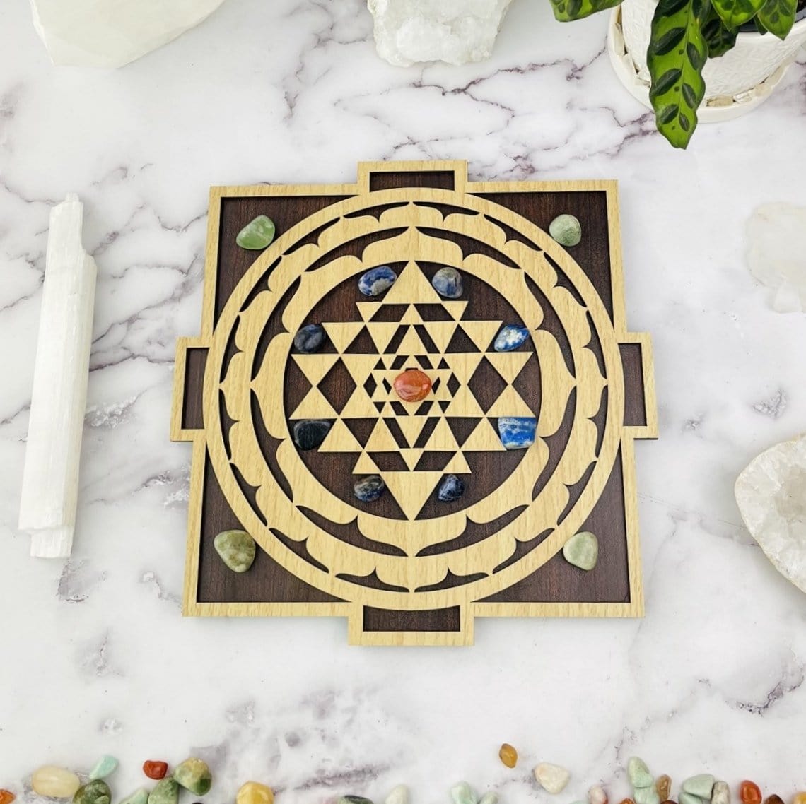 Crystal grid with crystals placed on top of it on marble background