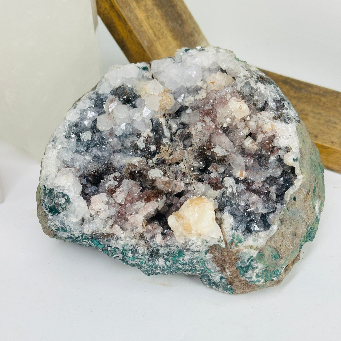 amethyst cluster with decorations in the background