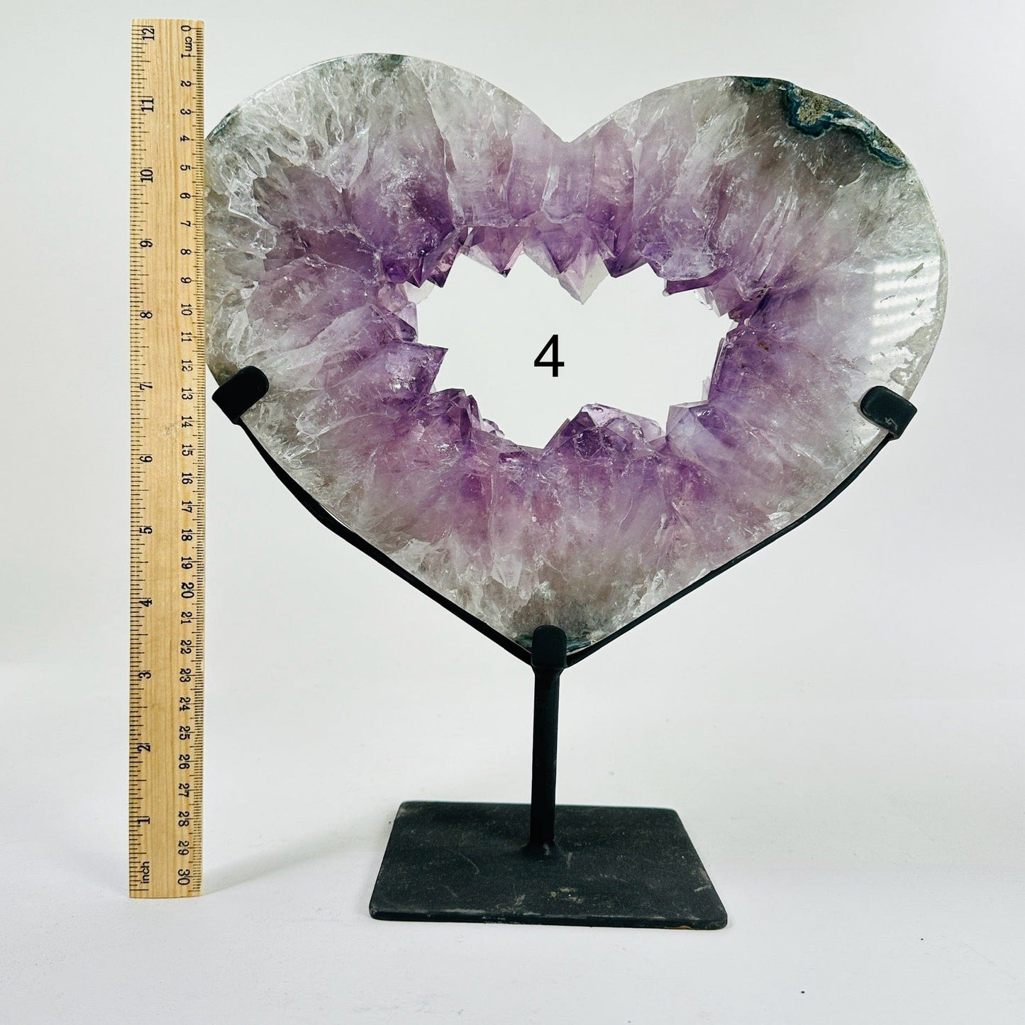 amethyst heart on stand next to a ruler for size reference