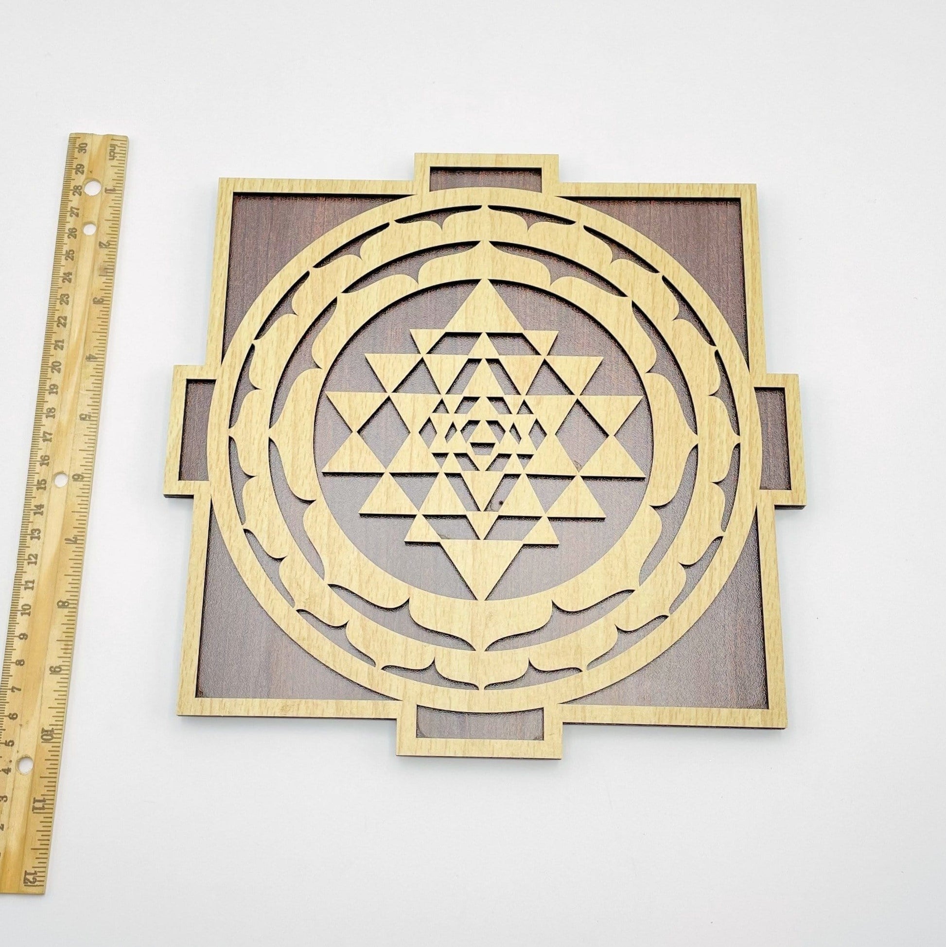 ruler next to crystal grid for size reference on white background