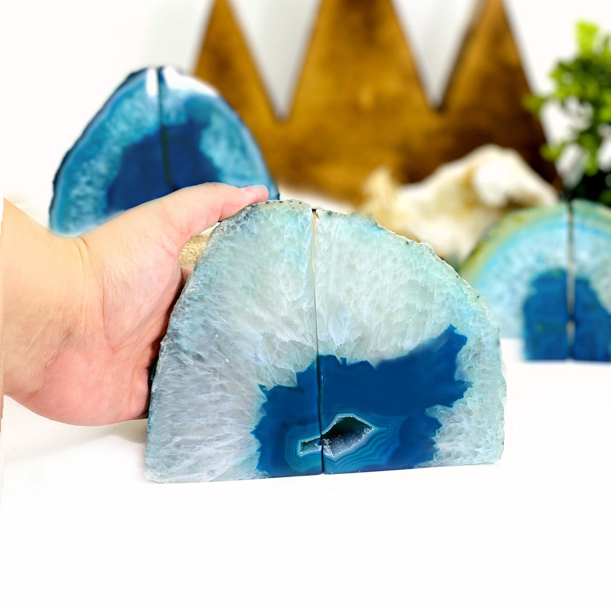 blue agate bookend with a hand next to it