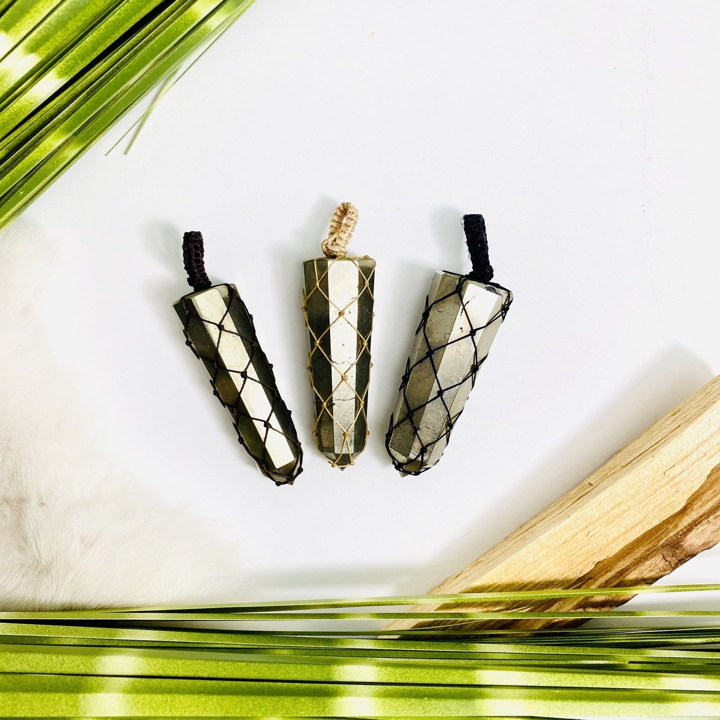Pyrite Point with String Netted Bail on a table