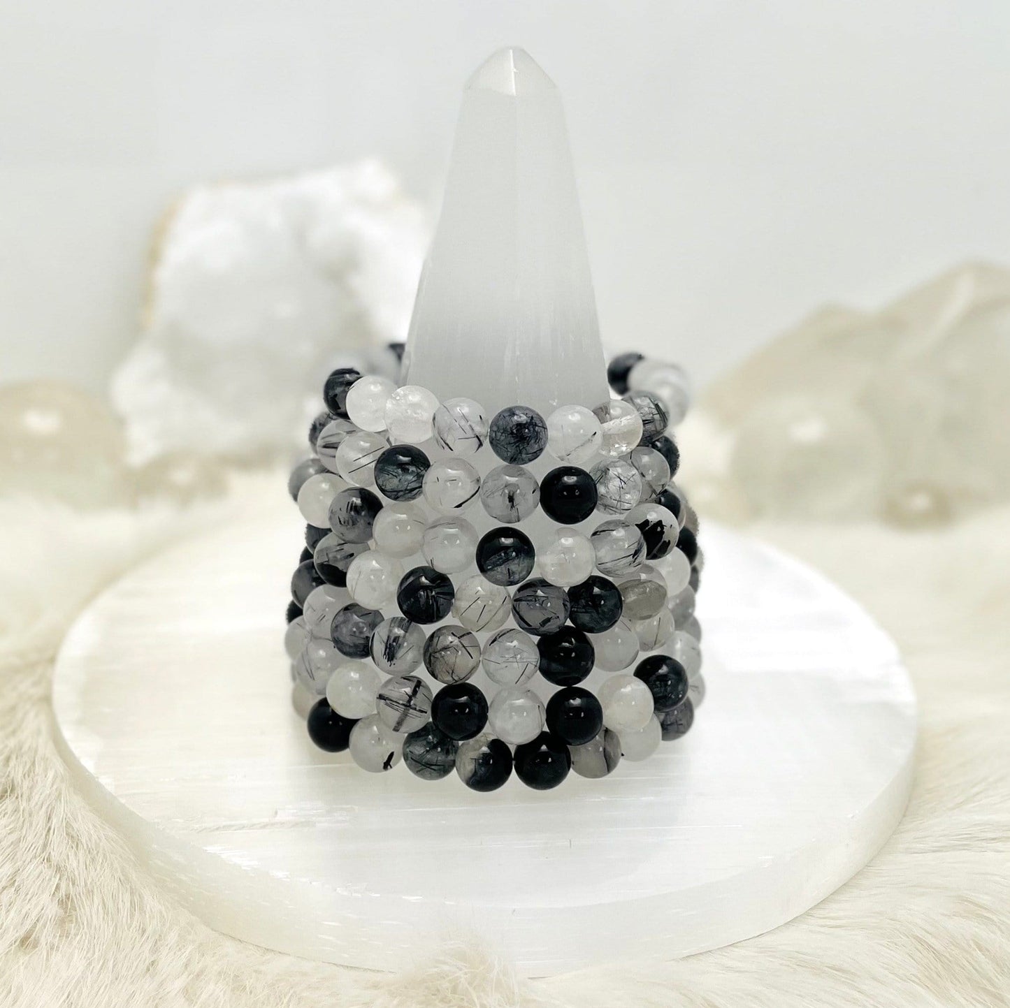 Black Rutilated Round Bead Bracelets  - a group on a stand
