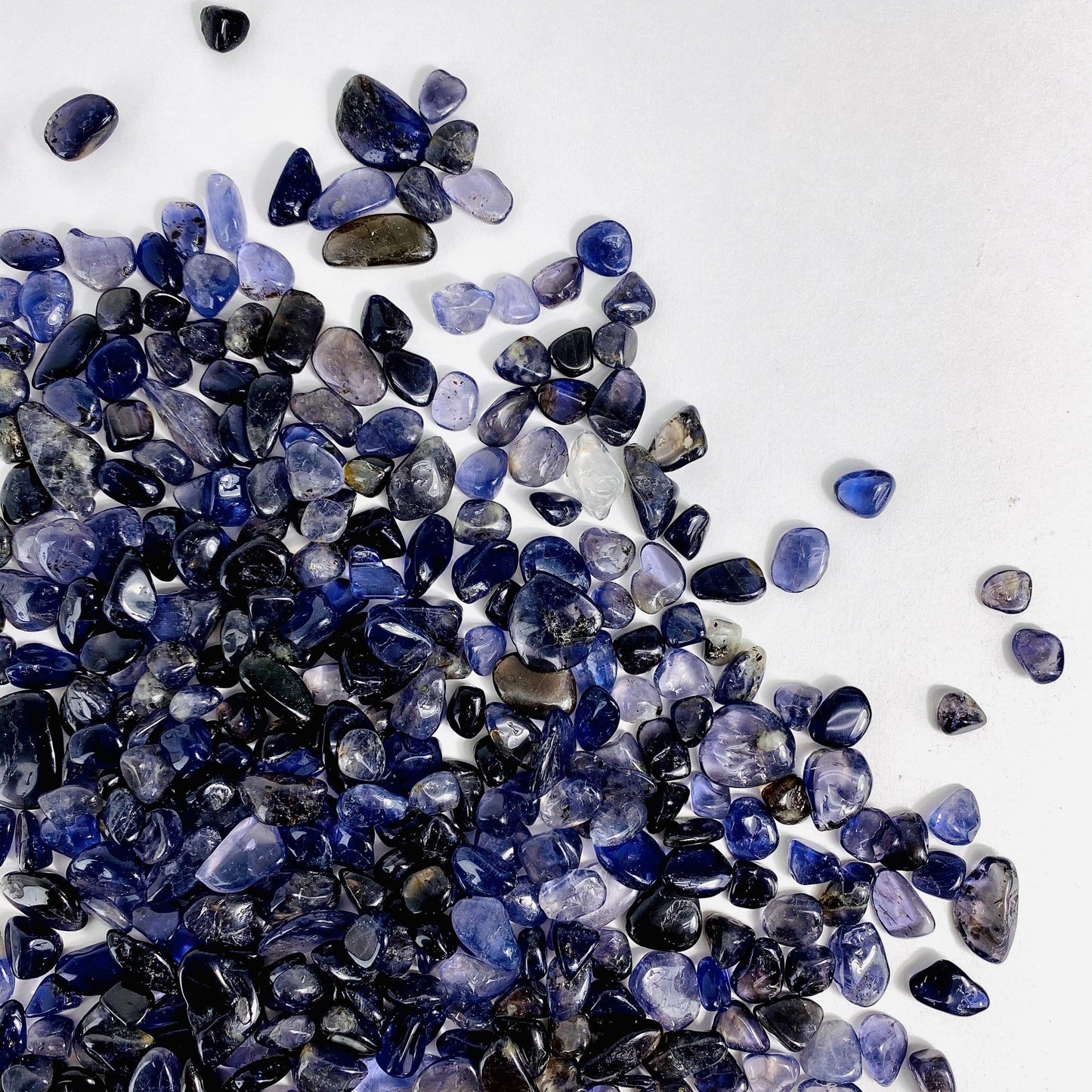 1lb Bag of Iolite Chips spread out on a table