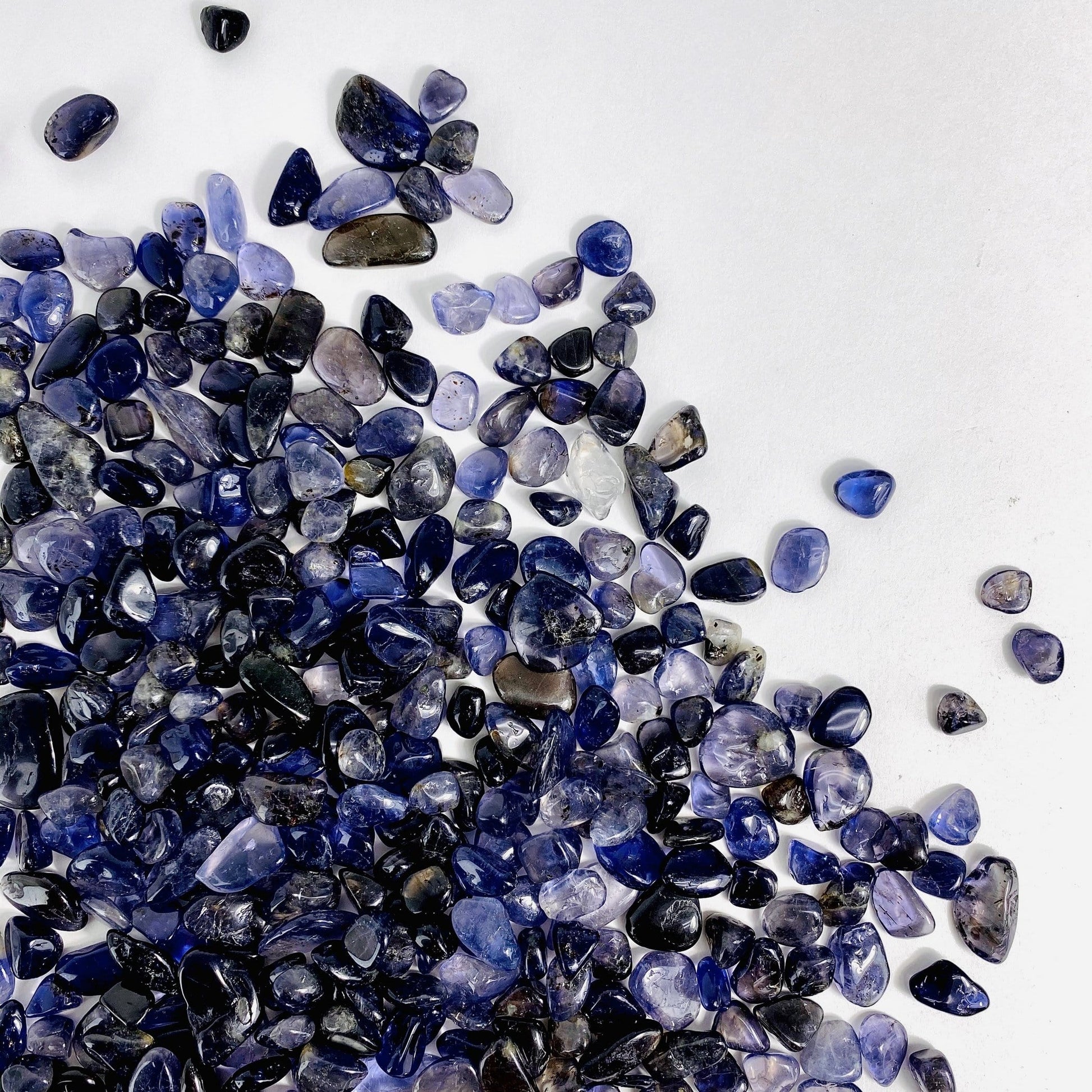 1lb Bag of Iolite Chips spread out on a table